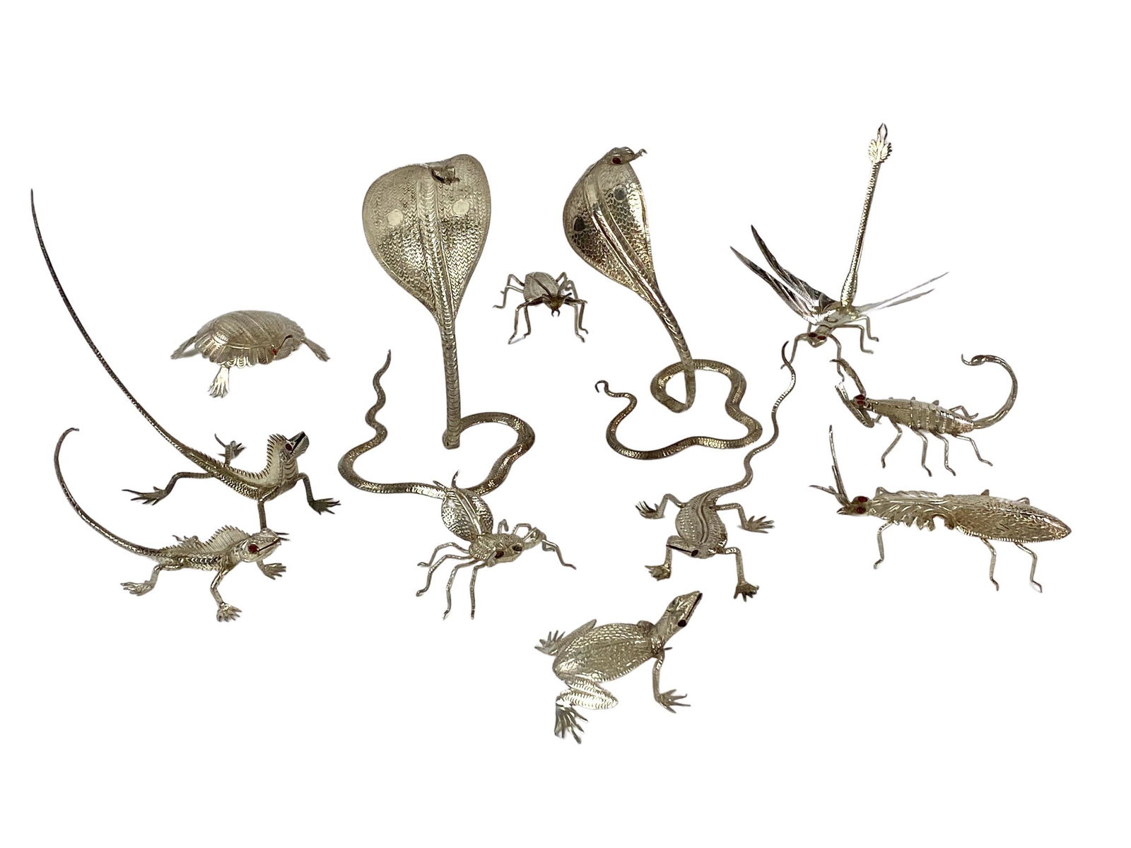 Set of 12 Indian Silver Insect/Reptile Menu Holders: Early to middle 20th century, a group of finely made Indian silver menu holders, in forms such as lizards, snakes, winged insects, and bugs. Several with bejewelled eyes. Tallest example 3.5".