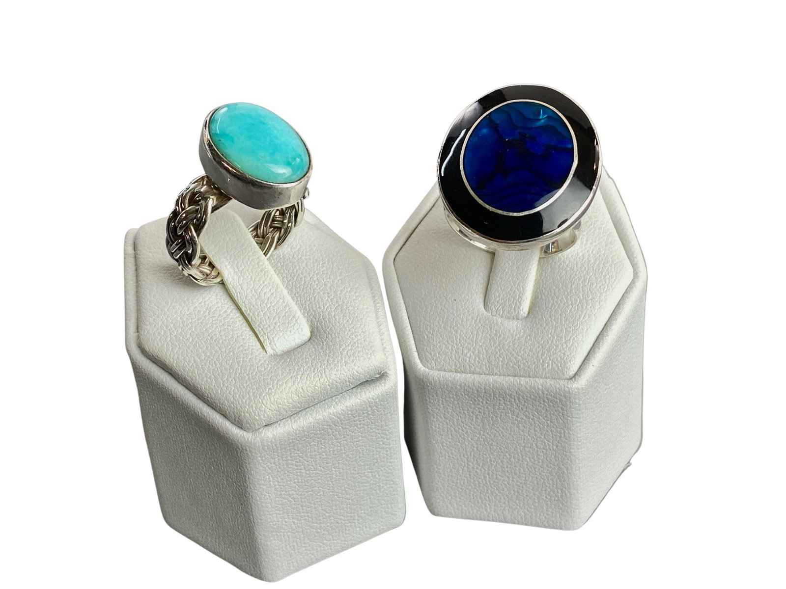 Pair of Sterling Silver Rings: One containing a turquoise stone and the other with blue glass in center. Total weight: 13.6 grams From the collection of prominent art historian and lecturer, Robert Allen, New York. Many items featu