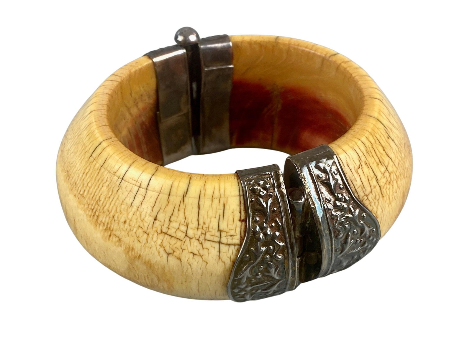 Mammoth Tusk Bangle Bracelet: Early 20th century, a mammoth tusk bangle with silver plated clasps. Diameter 3.5".