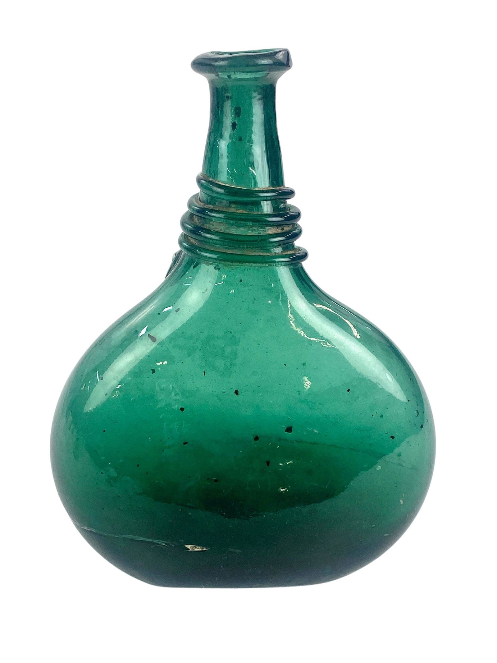 19th Century Blown Glass Bottle: Four overlaid swirls to the top, handblown, hues of green, 9" ht. x 7" wd. x 3" dp.