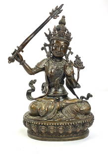 Sino-Tibetan Bronze Buddha, Early 20th Century: Hollow cast bronze with cover to underside, depicting a seated Buddha figure, early 20th century. Ht. 13.5".