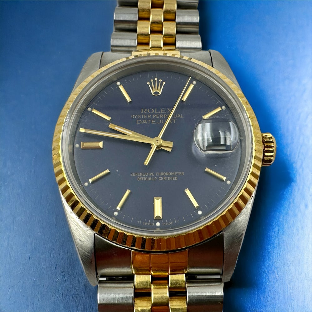 Rolex Oyster Perpetual Datejust Chronometer Wristwatch: 18k gold crown and fluted bezel, two tone with denim dial, 36mm Serial: E560938 Ref: 16233