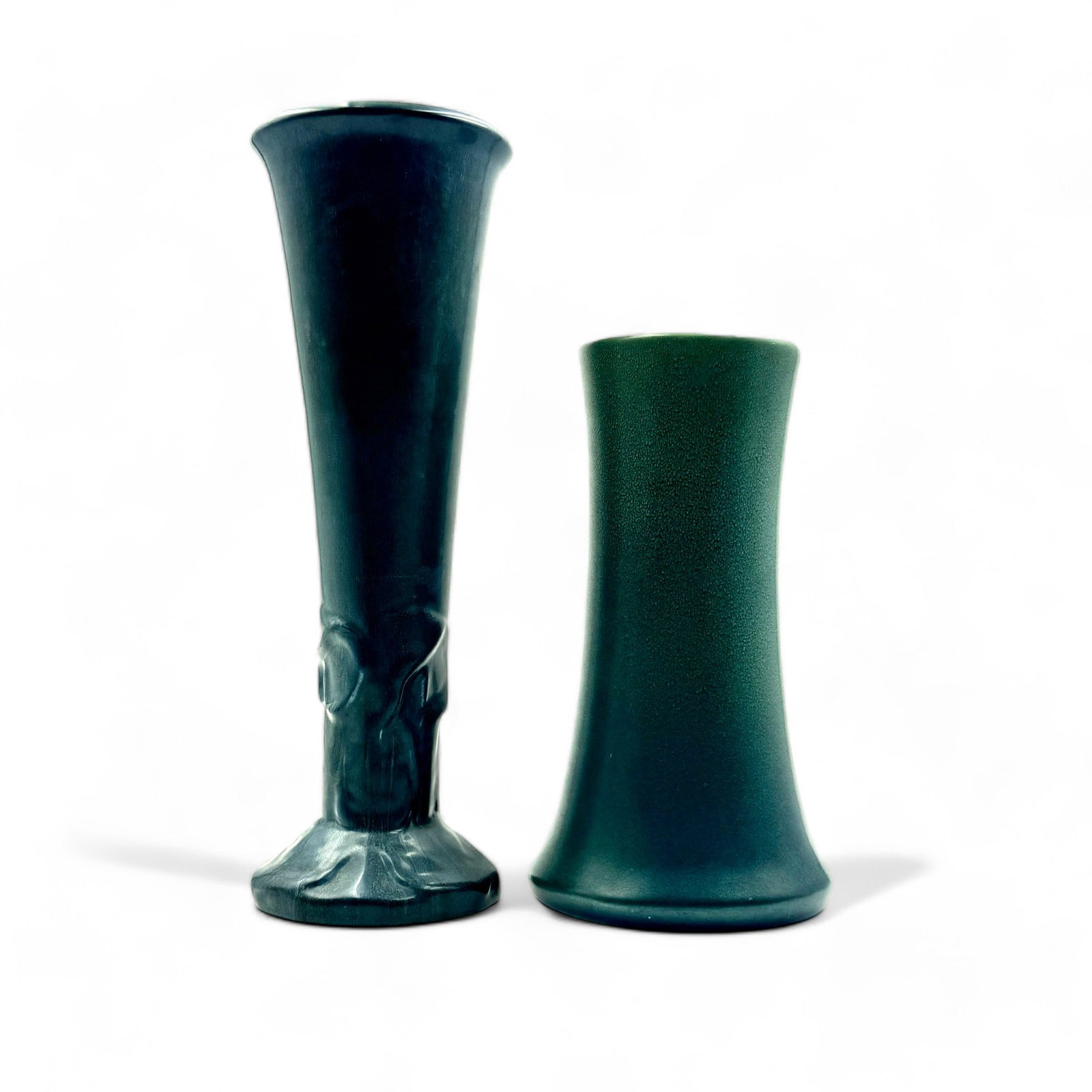 Pair of Matte Glaze Tall Rookwood Pottery Vases: One Arts & Crafts style cylinder vase with frog skin glaze, shape 1358C, 1917. Another trumpet vase with relief near foot of irises, shape 2010, 1920. Ht. of tallest 14.5".