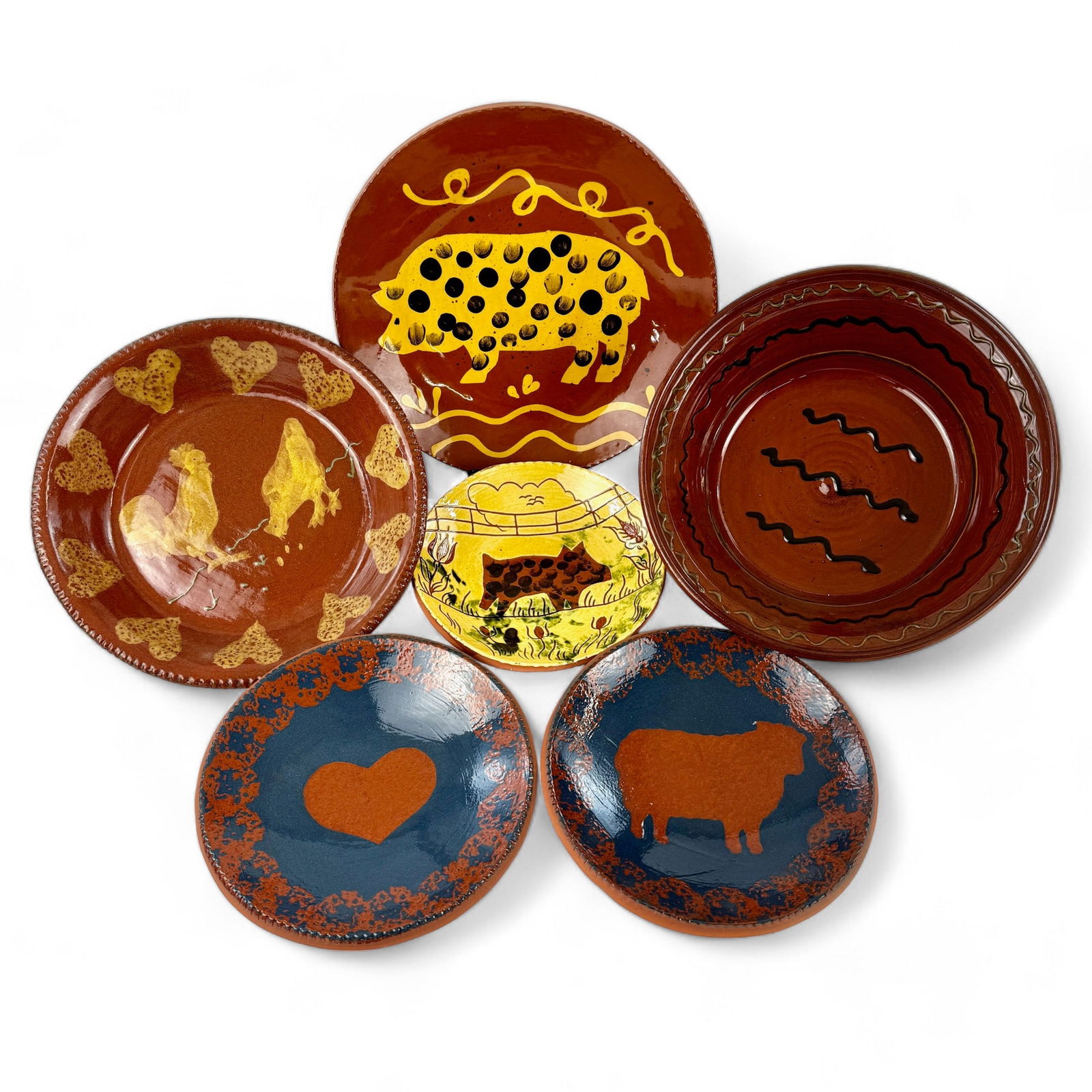 Grouping of Redware Pottery: Including three Breininger pottery examples, two depicting pigs and one simply decorative. Also including two matching, signed heart decorated redware pieces and one turtle creek example with chickens