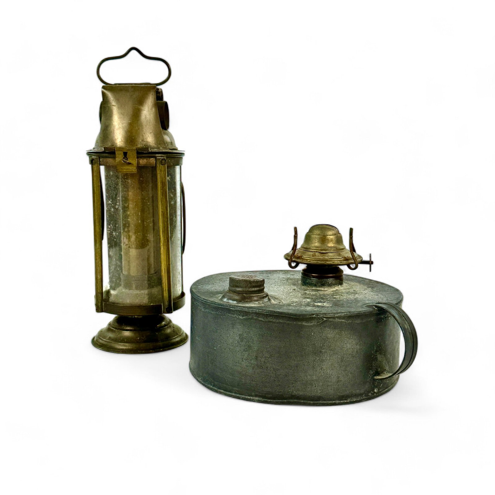 Pair of Antique Kerosene Lamps: One tin and one brass. The brass lamp extends upwards from the handle