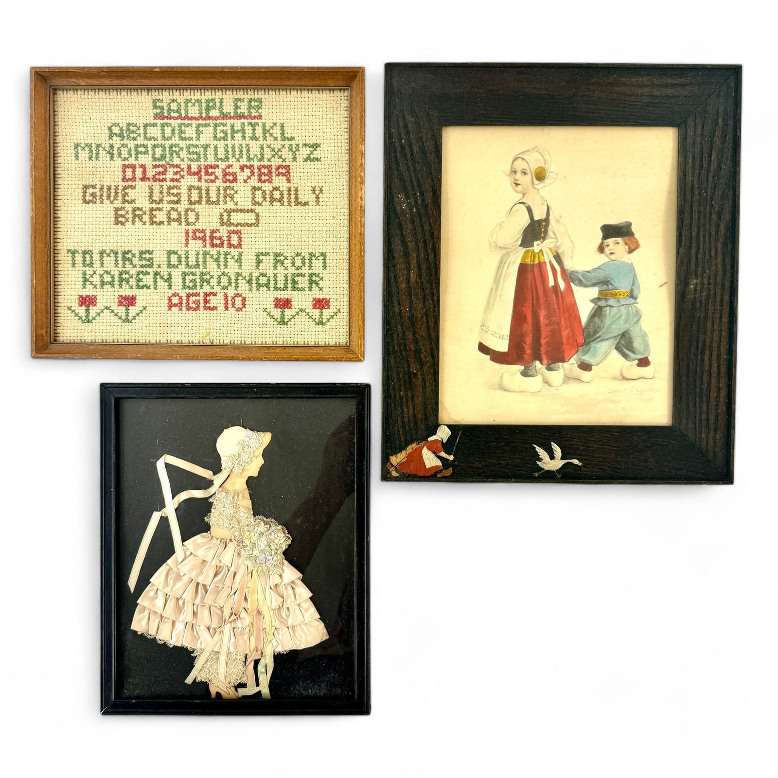 Trio of Antique Framed Pieces: Including a cutout profile view of a young girl with lace dress and floral bouquet, a sampler and a watercolor of a young boy and girl. Largest framed size: 13.5" ht. x 11" wd.