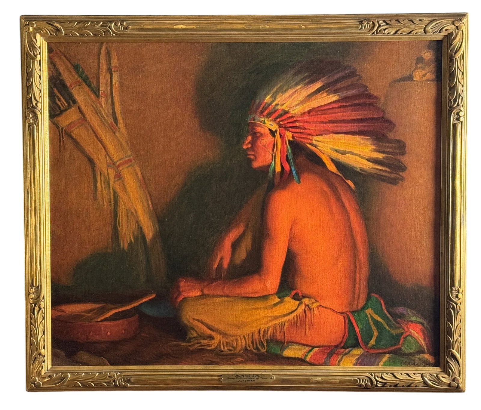 "Young Medicine Man of Taos" by Joseph Henry Sharp: Hunting Son: Young Medicine Man of Taos Oil on canvas Signed l.r., “JH Sharp, Taos” Suder’s label and family inscription to verso Housed in the original carved and giltwood frame. Plaque to