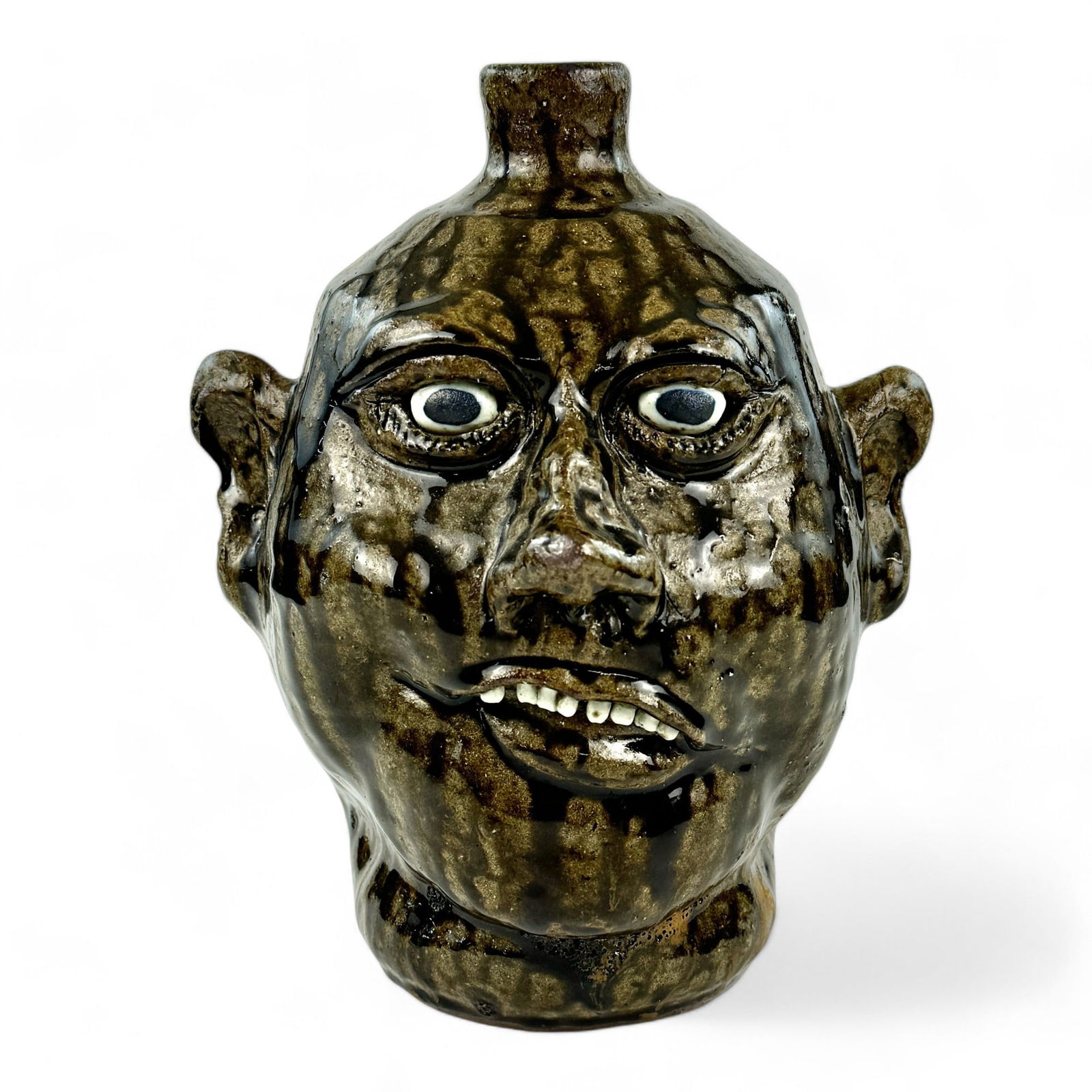 Lanier Meaders Tobacco Spit-Face Jug: Lanier Meaders (American, 1917-1998). A pottery face jug with tobacco glaze, a "spit-face" example by Meaders. Signed to the underside. Ht. 10.5".