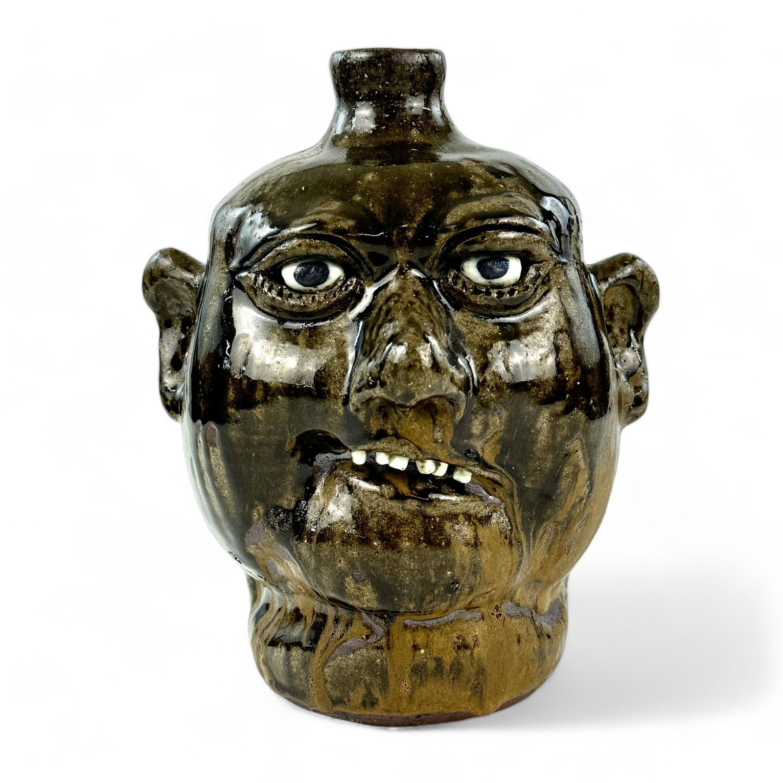 Lanier Meaders Tobacco Spit-Face Jug: Lanier Meaders (American, 1917-1998). A pottery face jug with tobacco glaze, a "spit-face" example by Meaders. Signed to the underside. Ht. 9.75".
