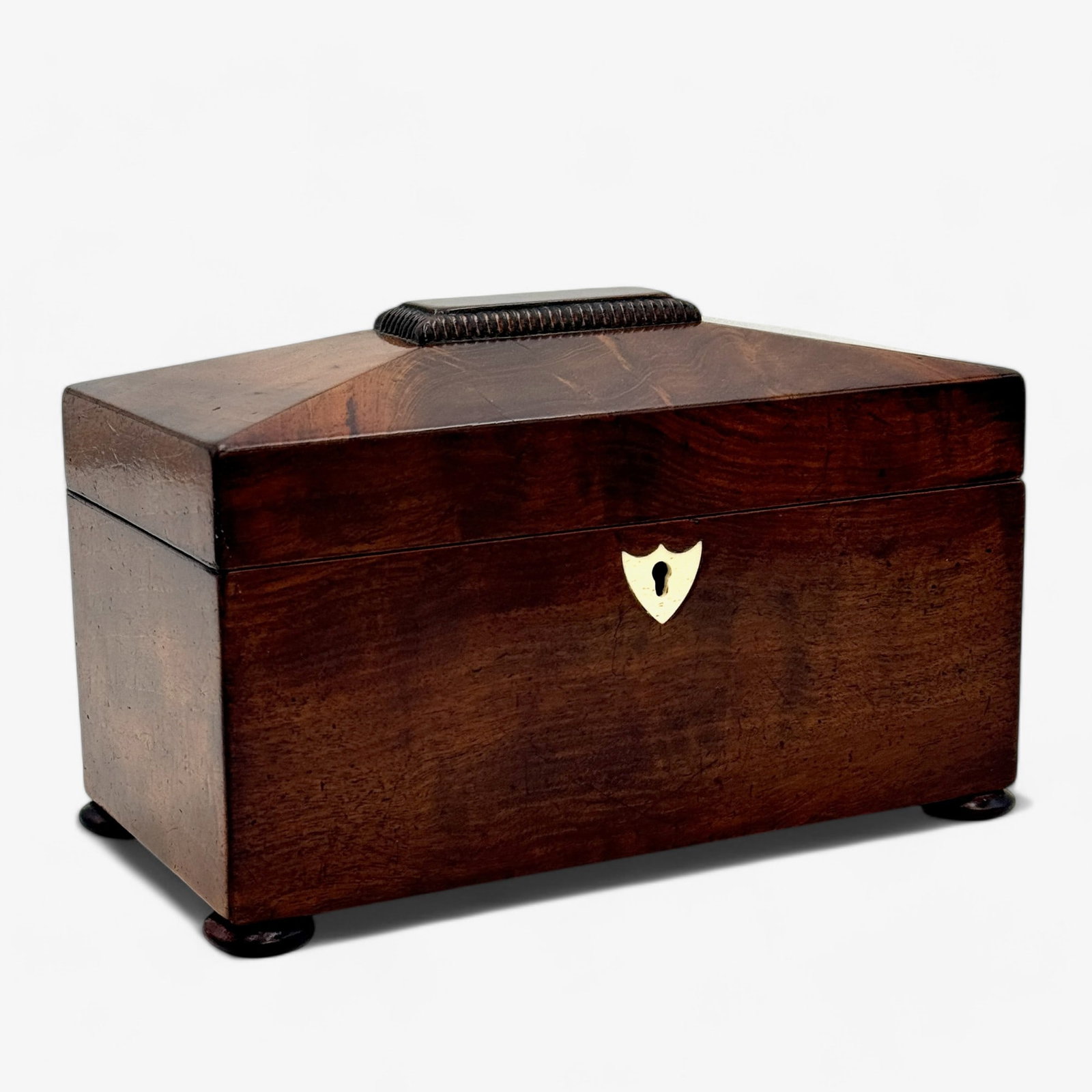 English Mahogany Tea Caddy: 19th century, a mahogany tea caddy with bone insert, pair of interior containers each with cover. Ht. 5.5", lg. 8", dp. 4.5".