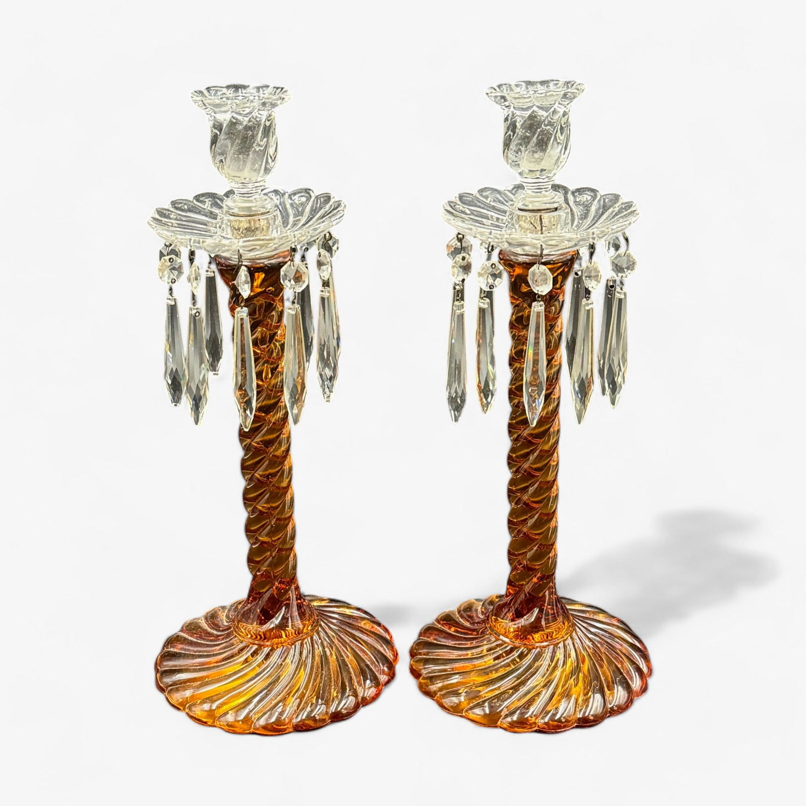 Pair of Glass Candlesticks: Base and stem consist of swirl pattern in amber, both with crystal holders and 10 dangling crystal pieces. Height of each: 14.5"