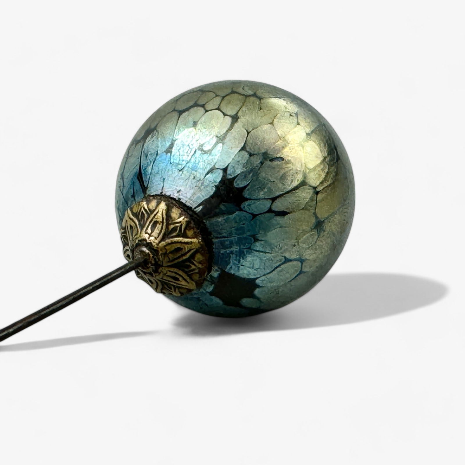 Loetz Iridescent Hatpin: Ca. 1900, a Loetz iridescent glass hatpin, with ormolu pin. Lg. 11".