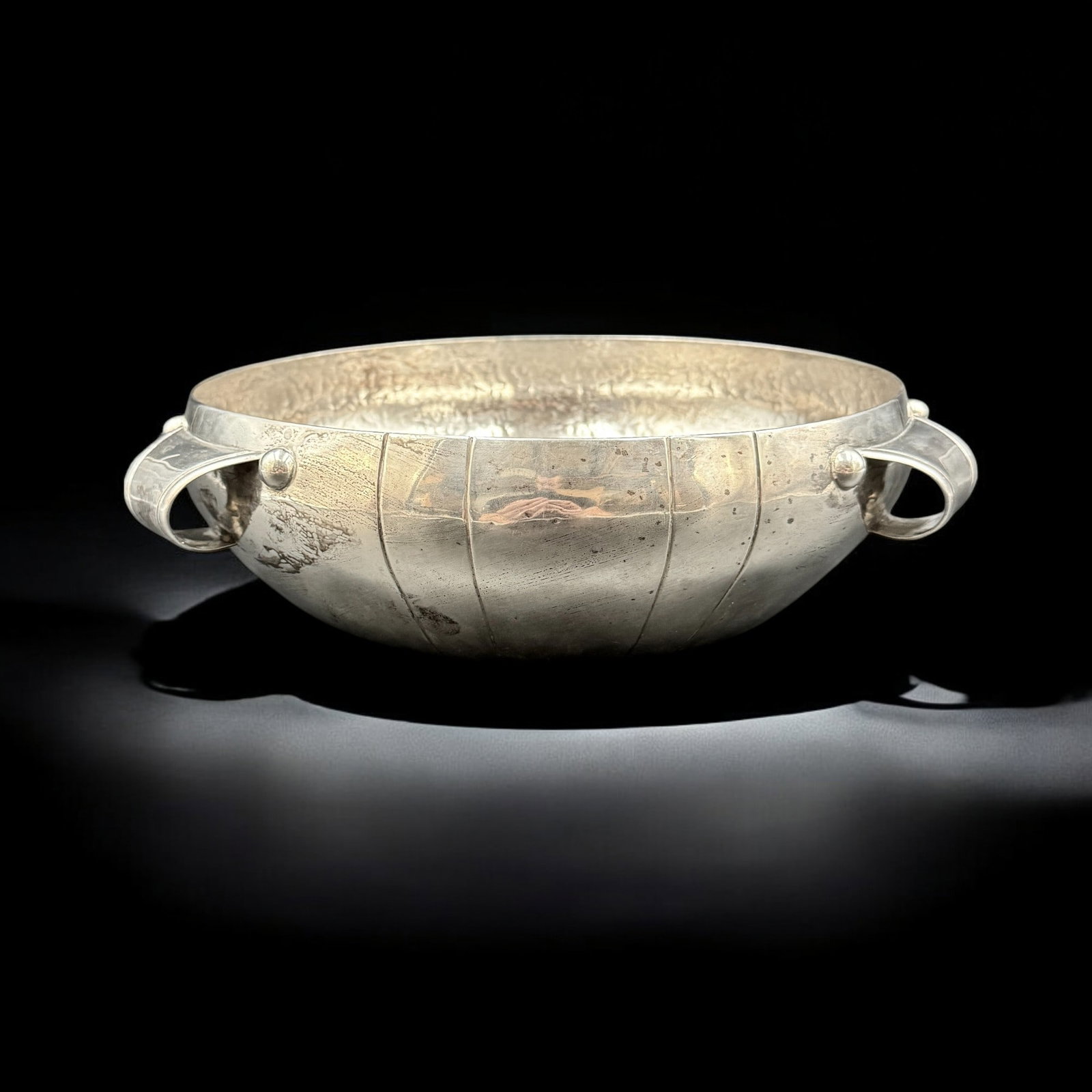 Spratling Mexican Sterling Bowl: An Arts & Crafts sterling bowl, marked for "Spratling, Made in Mexico" and sterling, with lobed edges, hammered interior and stylized handles. Diameter 10.5". Total weight 31.24 ozt.
