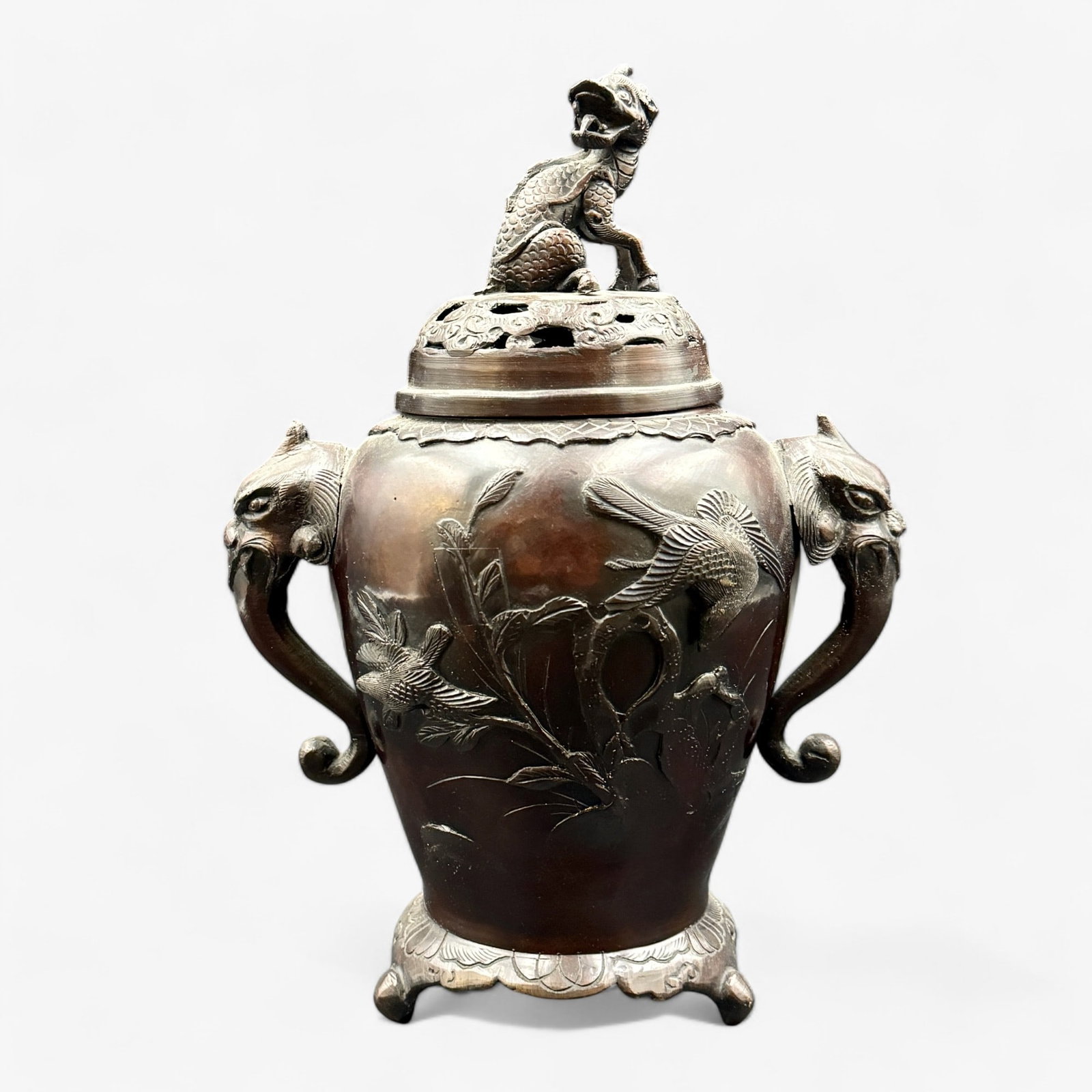 Japanese Bronze Vase and Cover: Japanese, early 20th century. A bronze vase with beast handles, pierced cover with beast and other relief decoration. Ht. 12.5".