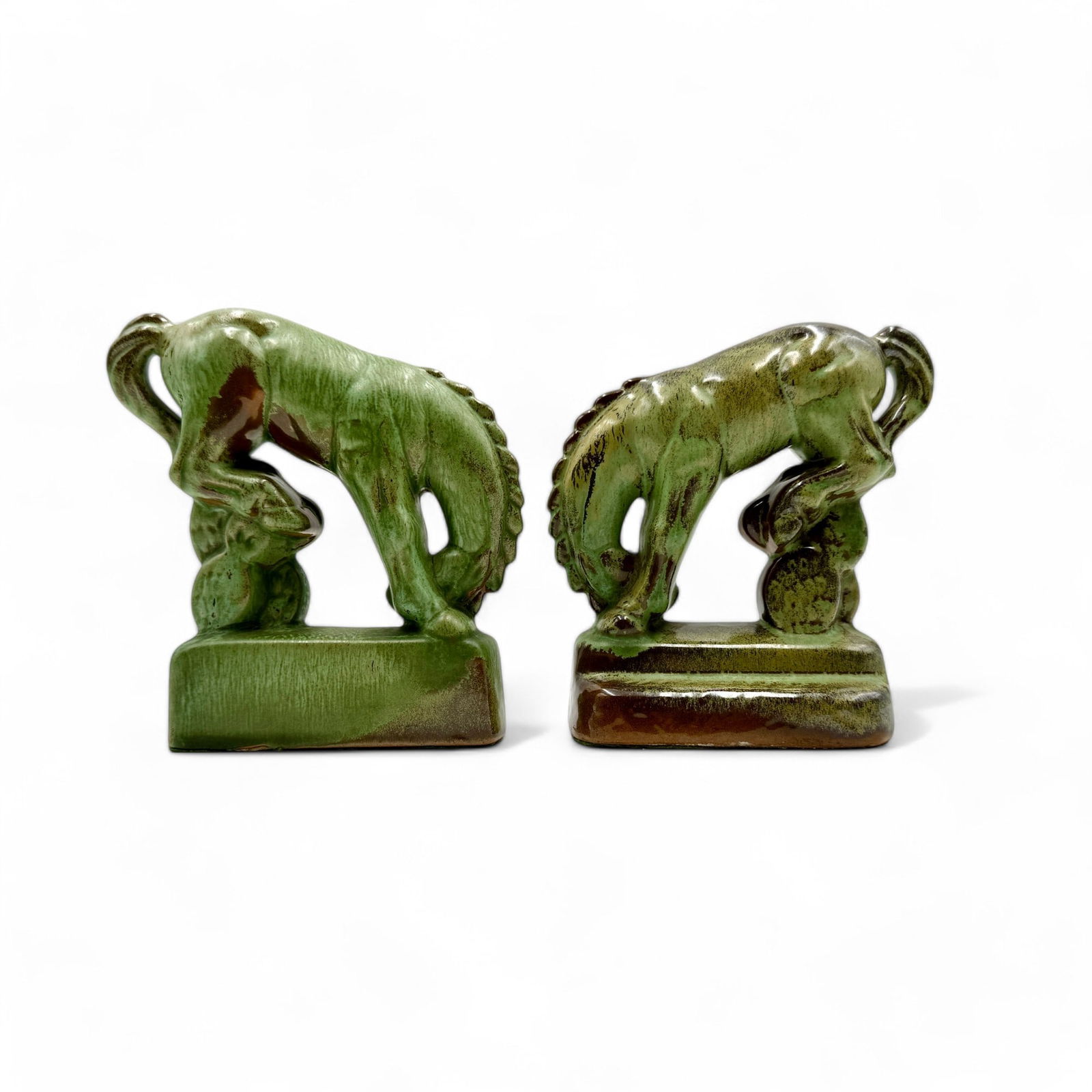 Frankoma Bucking Bronco Bookends: Frankoma bucking bronco bookends circa 1942-1949. Glazed Prairie Green. 5.75" ht. Glaze flake on bottom rim.