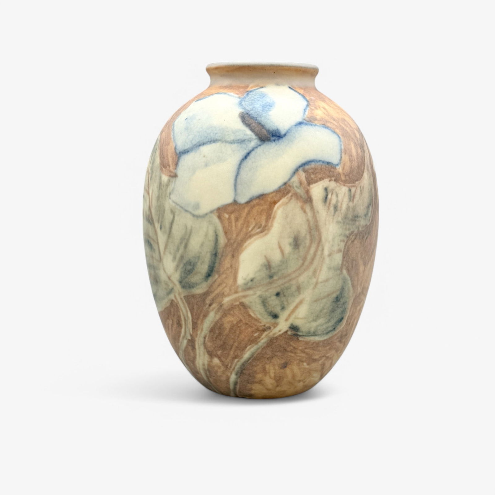 Jens Jensen for Rookwood Pottery: 1945, shape number 6184E, impressed Rookwood stamp and artist's cipher to base. Floral decorated vellum vase. Height: 7.25"