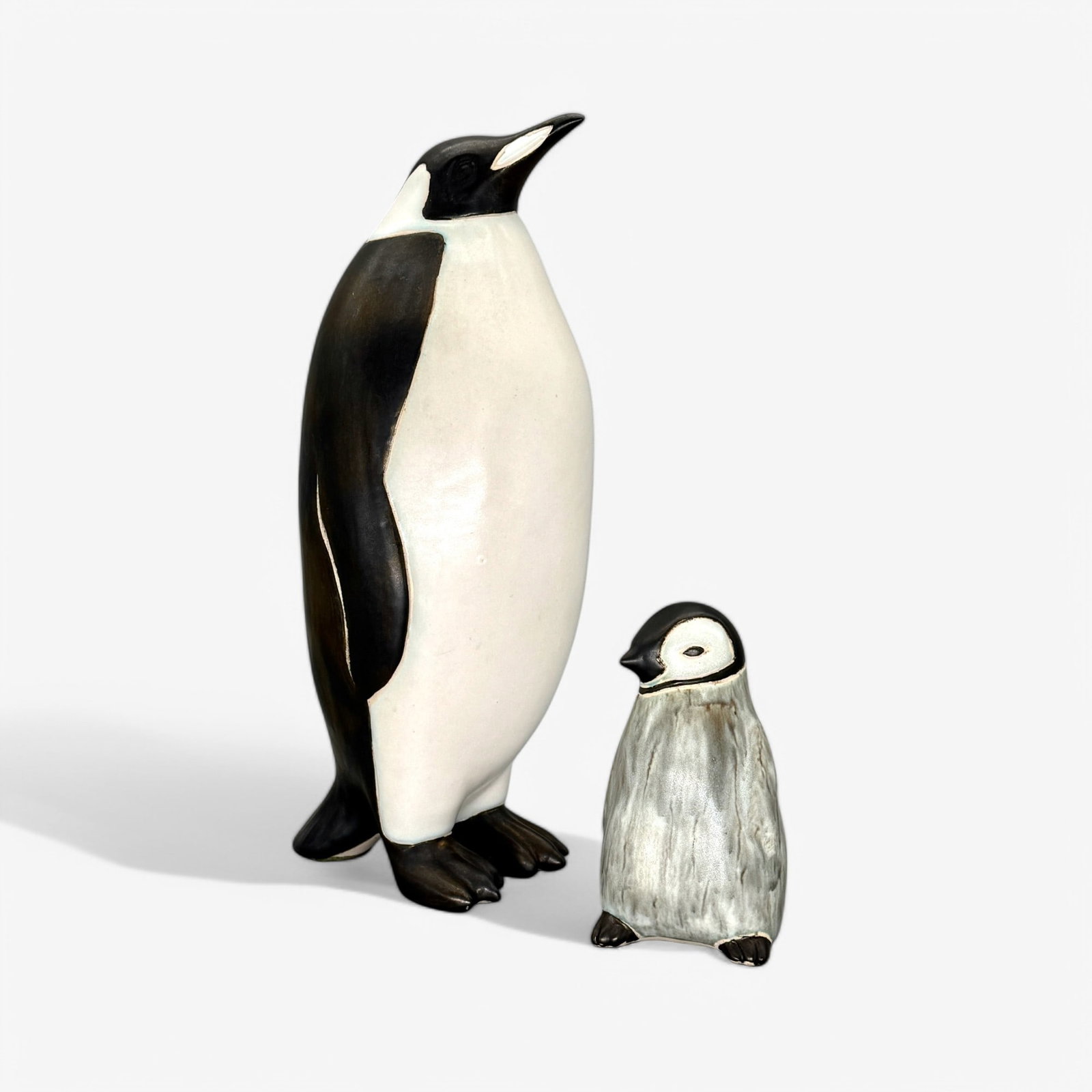 Pair of Andersen Design Maine Pottery Penguins: A pair of penguins, including a tall standing example, and a young baby. Each initialed. Tallest ht. 12".