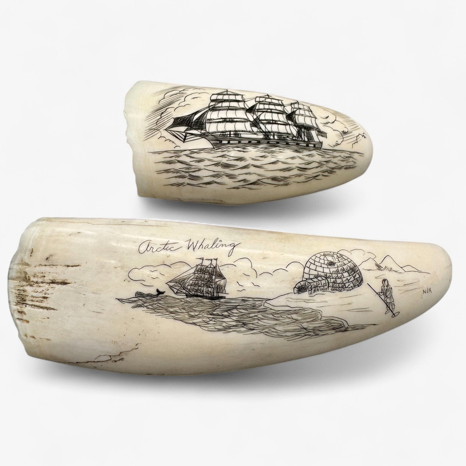 Pair of Two Scrimshawed Teeth: One depicting an arctic whaling scene with eskimo ice fishing and the other depicting a ship named liberty.