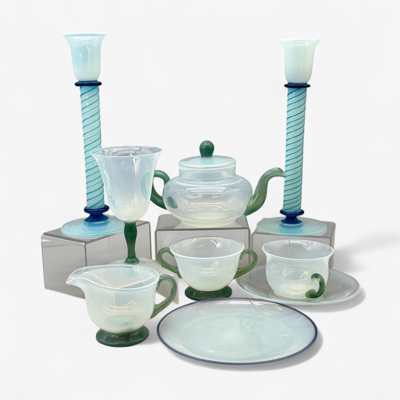 H.C. Fry Glass Grouping: Opalescent glass table wares, including teapot with creamer and sugar bowl, and one teacup. Also, pair of blown twisted candlesticks, wine glass, and two small side plates. Candlesticks measure 10.25"