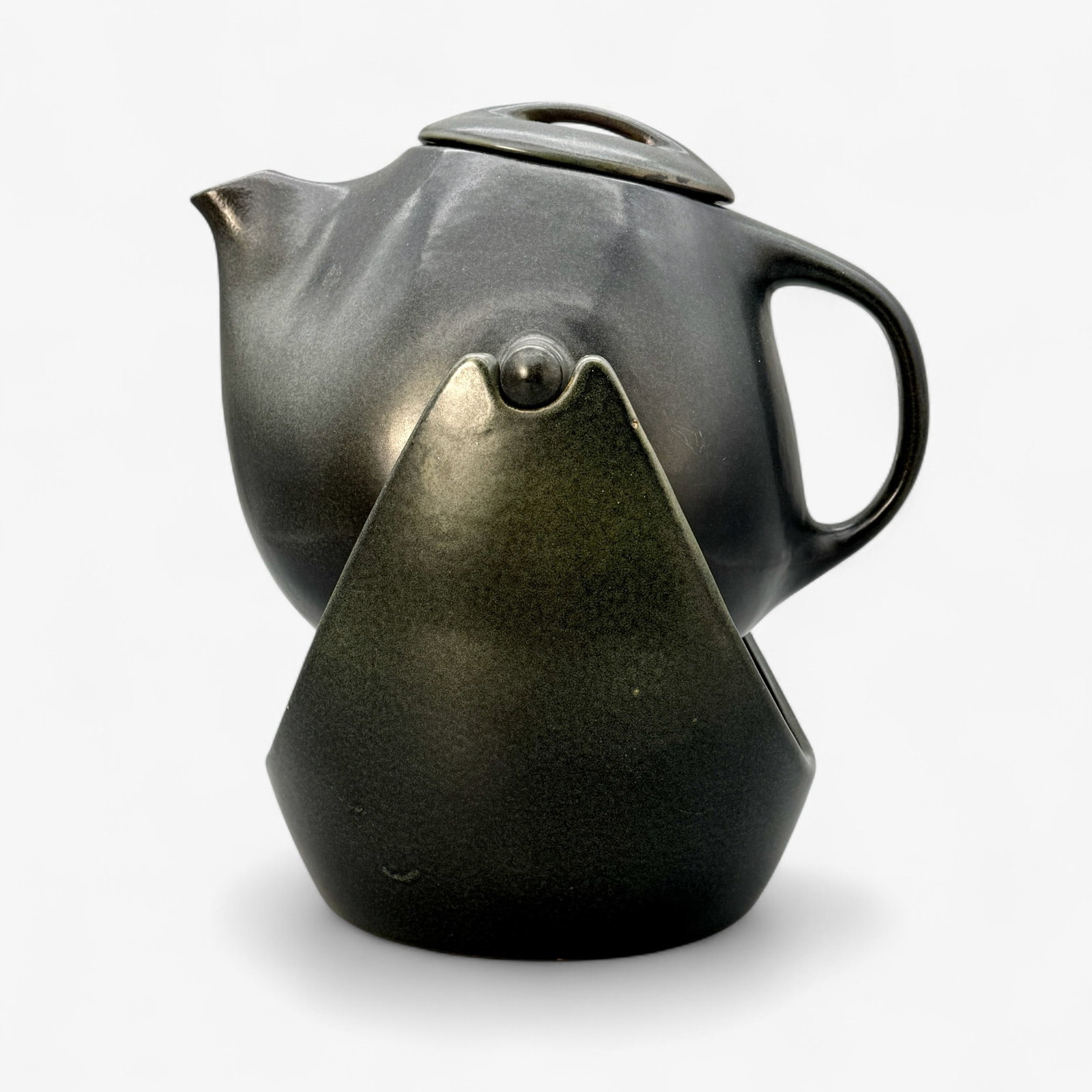 Roseville Raymor Large Teapot: Large teapot, in dark green to black mat finish. With stand. Lid in tact. 9" ht.