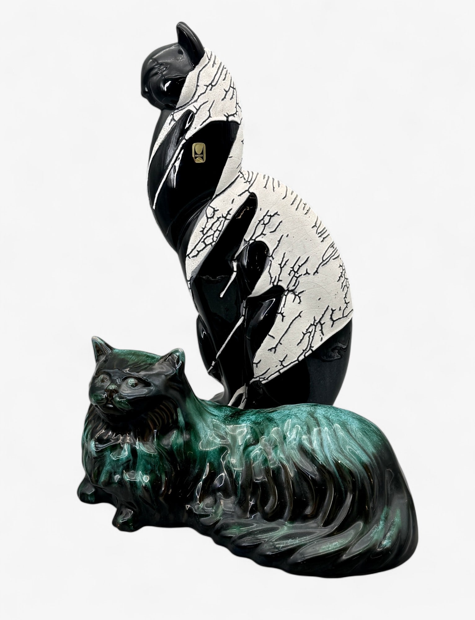 Pair of Haeger and Blue Mountain Pottery Cats: One reclined version in green drip glaze and one black and white seated version with sticker to side. Height of tallest: 21"