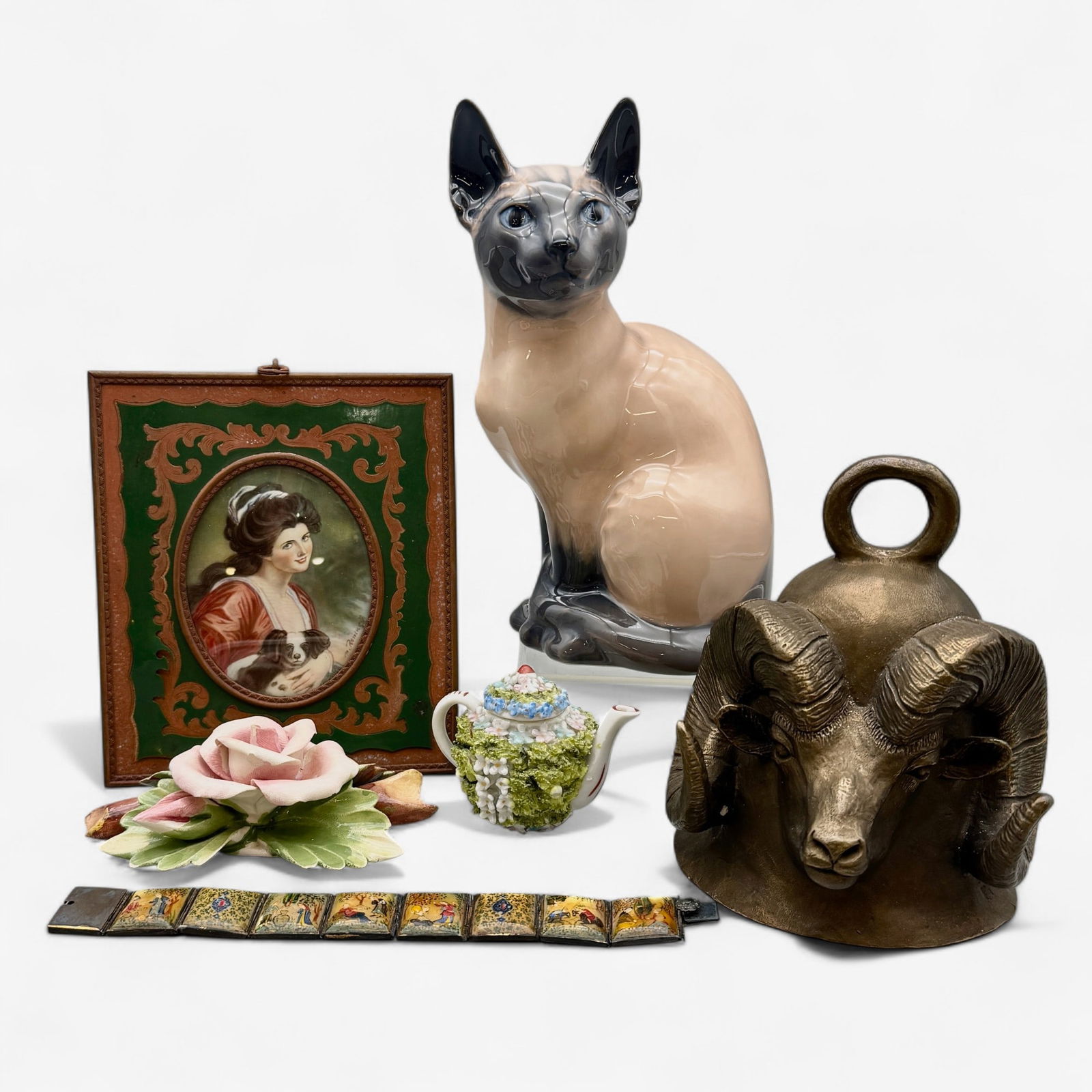 Collection of European Souvenirs: Including a Royal Copenhagen cat, a ram form brass bell, a painted miniature, a Capodimonte cabinet teapot and floral weight, and finally a painted mother of pearl bracelet. Cat ht. 8".