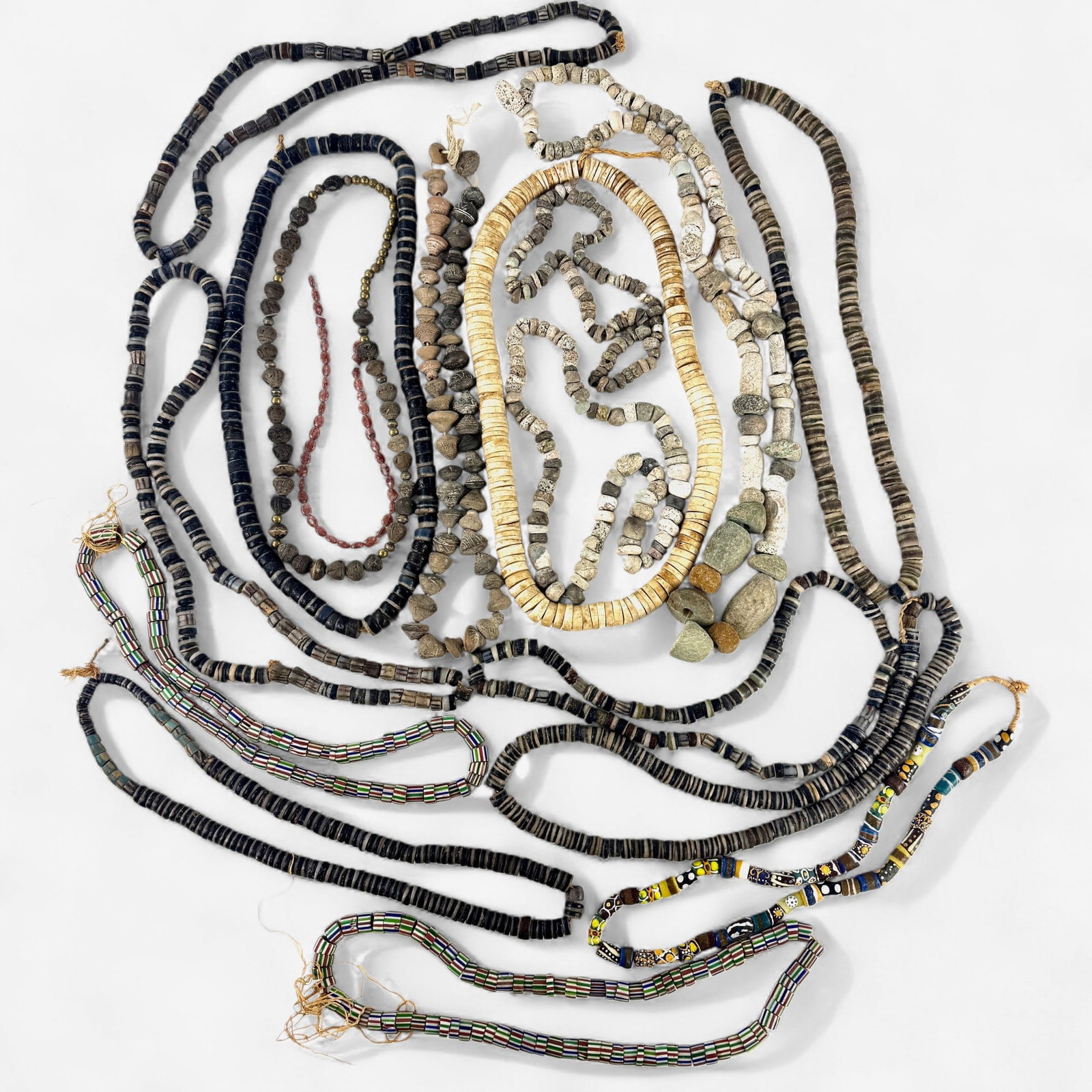 Variety of Stone and Trade Bead Necklaces: Multiple media, mostly stone with others including trade beads, and carved stone beads with metals added.