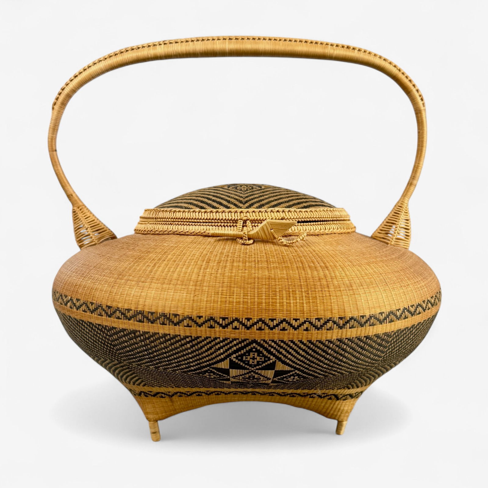 Meticulous Thai Hand Woven Basket: 20th century, a hand woven bamboo basket with interwoven design to cover and body, label to interior from "The 'Support' Foundation, Thailand. Ht. 8.75".