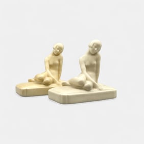Two Rookwood "nude" paperweights in white, 1927 and 1936.
