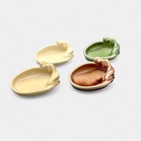 Four Rookwood "Nude" pin trays in various glazes.