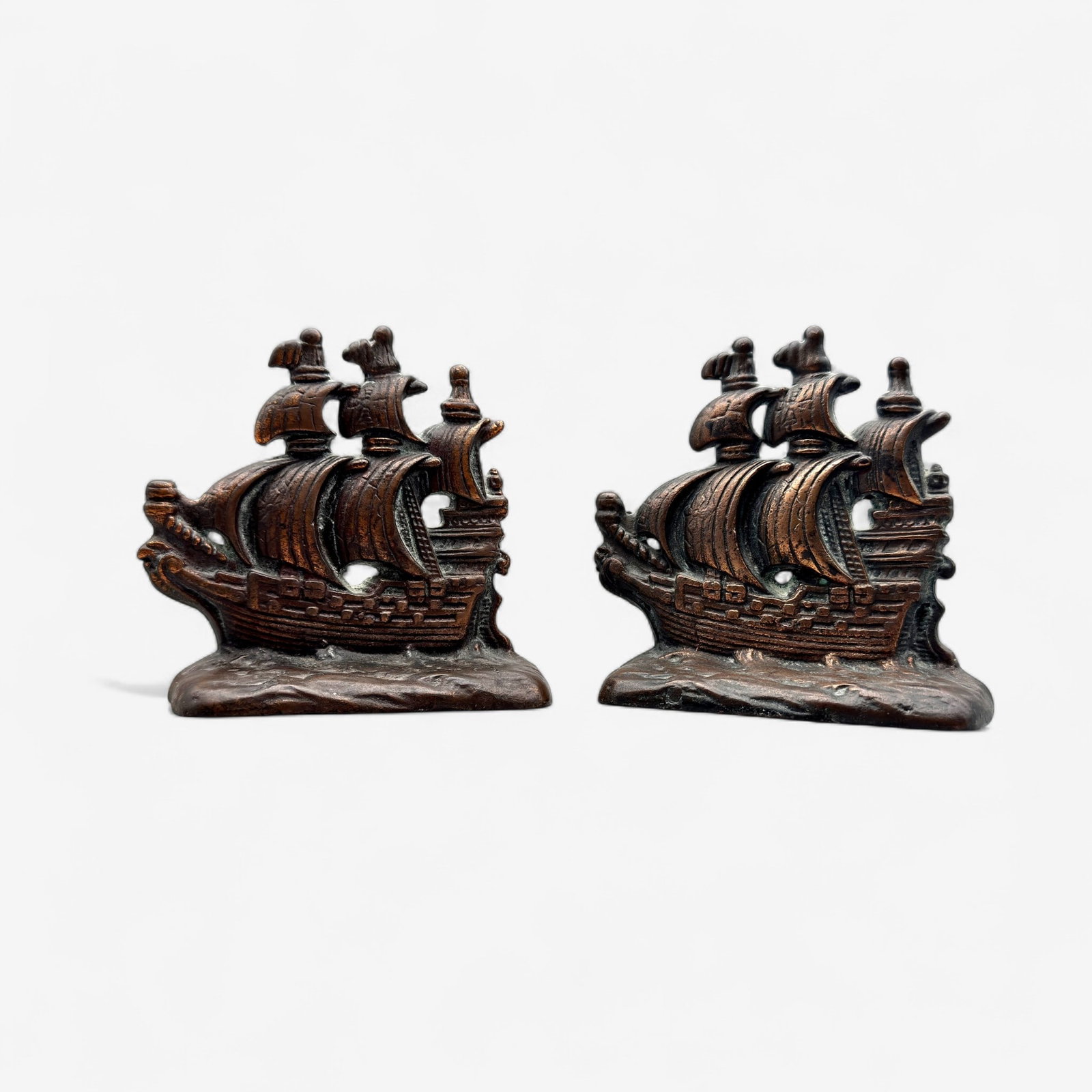 Pair of Bookend Pairs: First, a set of galleon ship with fine patina, no discernible markings, or Foundary stamps. Each 5 1/2" ht. And then a pair of Don Quixote carved wood bookends, each 9" ht.