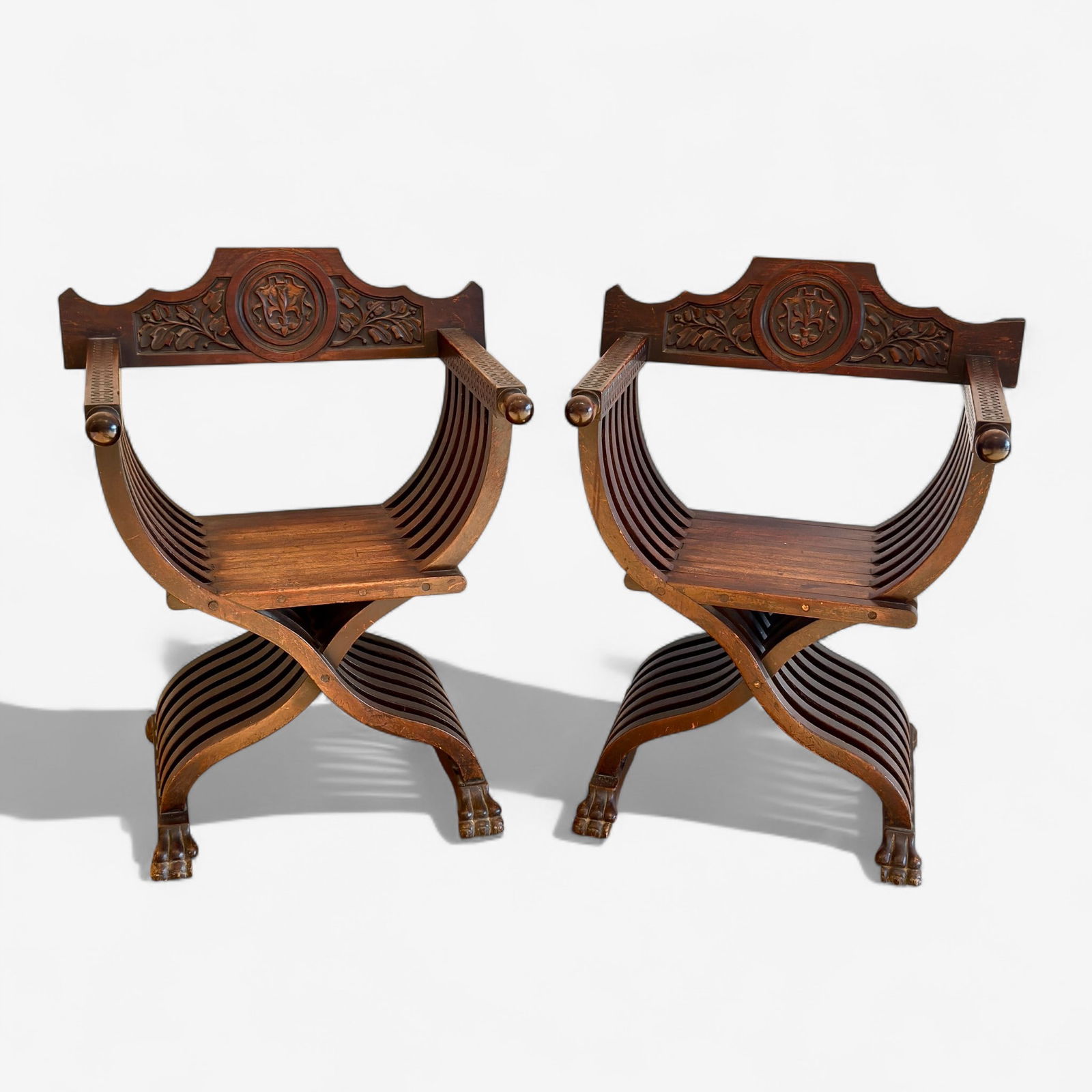 Pair of Savaronola Chairs: A pair of matching and heavily carved Savaronola chairs. Ht. of each