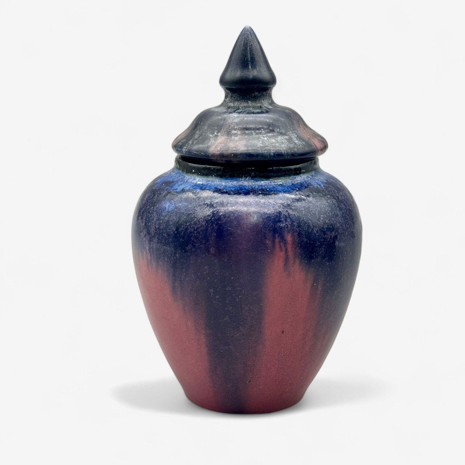 Fulper Pottery Vase with Lid: Marked Fulper to underside, glaze effect vase in blues and pink. Accompanied by a lid which has a slightly different glaze and sheen, suggesting that this lid is a later addition and/or marriage to th