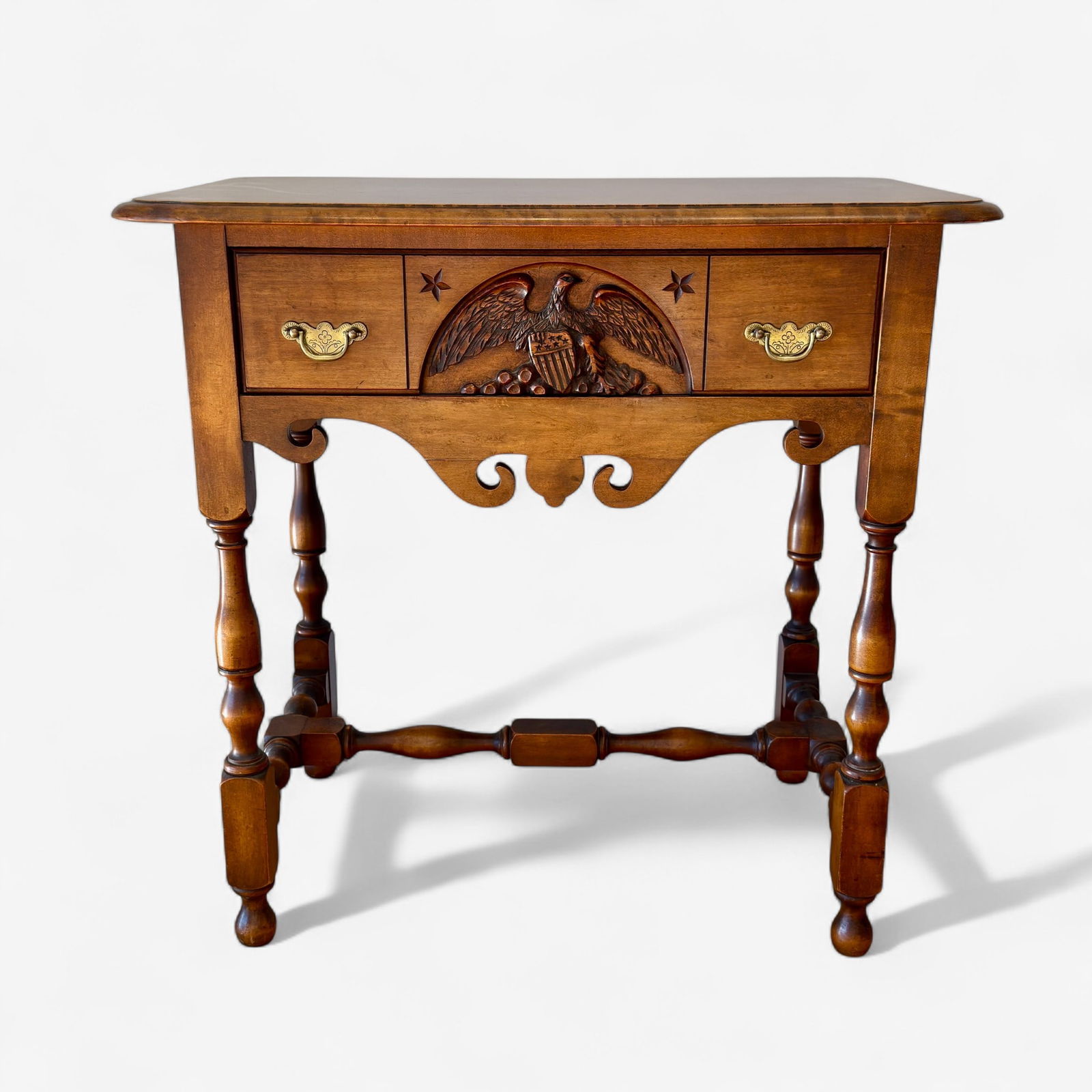 Old Ironsides Table with Paperwork: An eagle drawered table cut from parts of Old Ironsides, with news articles related to the making of 100 such examples, designed by Wallace Nutting. Ht. 29", wd. 30", dp. 17.5".