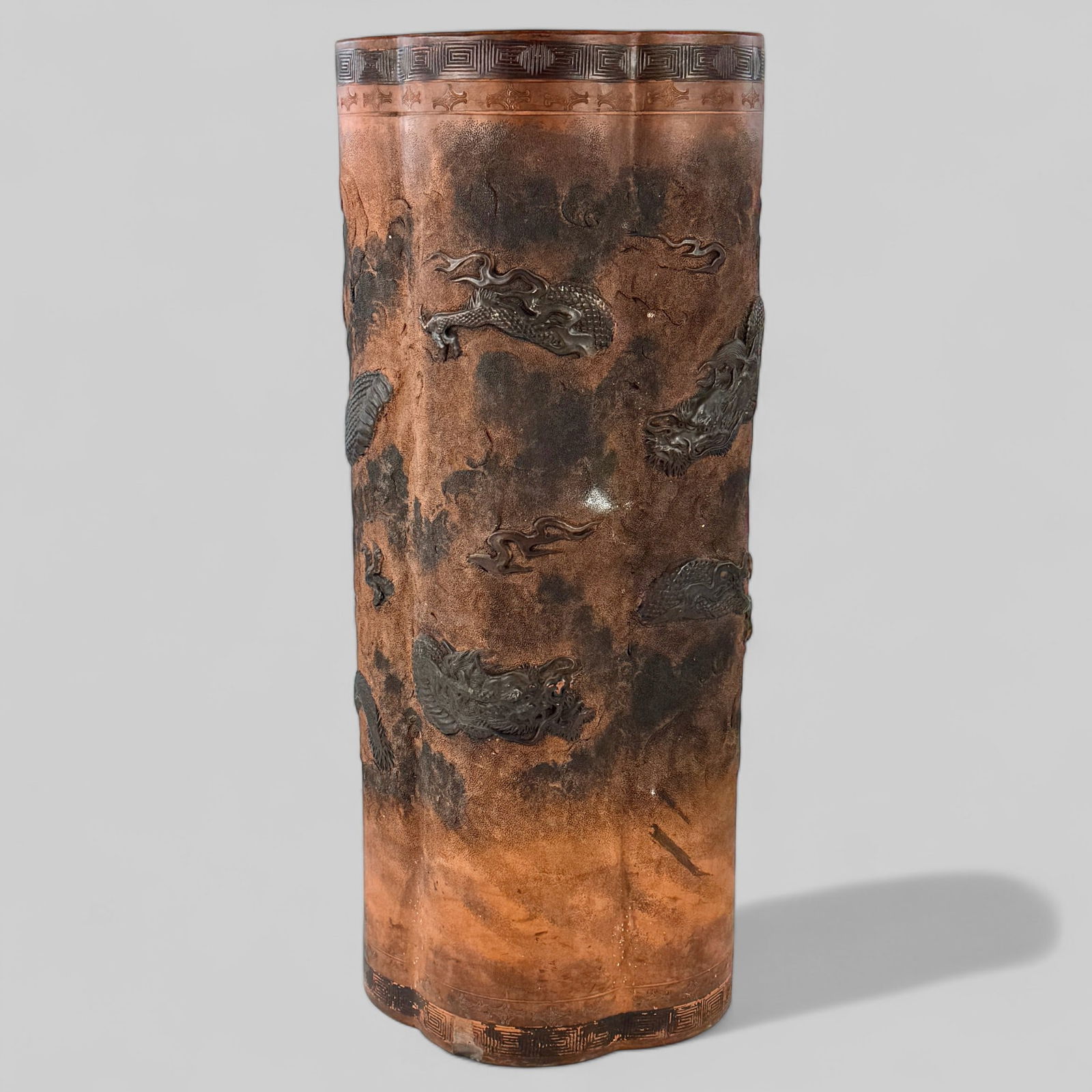 Chinese Terra Cotta Relief umbrella Stand: Early 20th century, though with an apocryphal, earlier mark. Dragons and other designs in relief. Ht. 25".