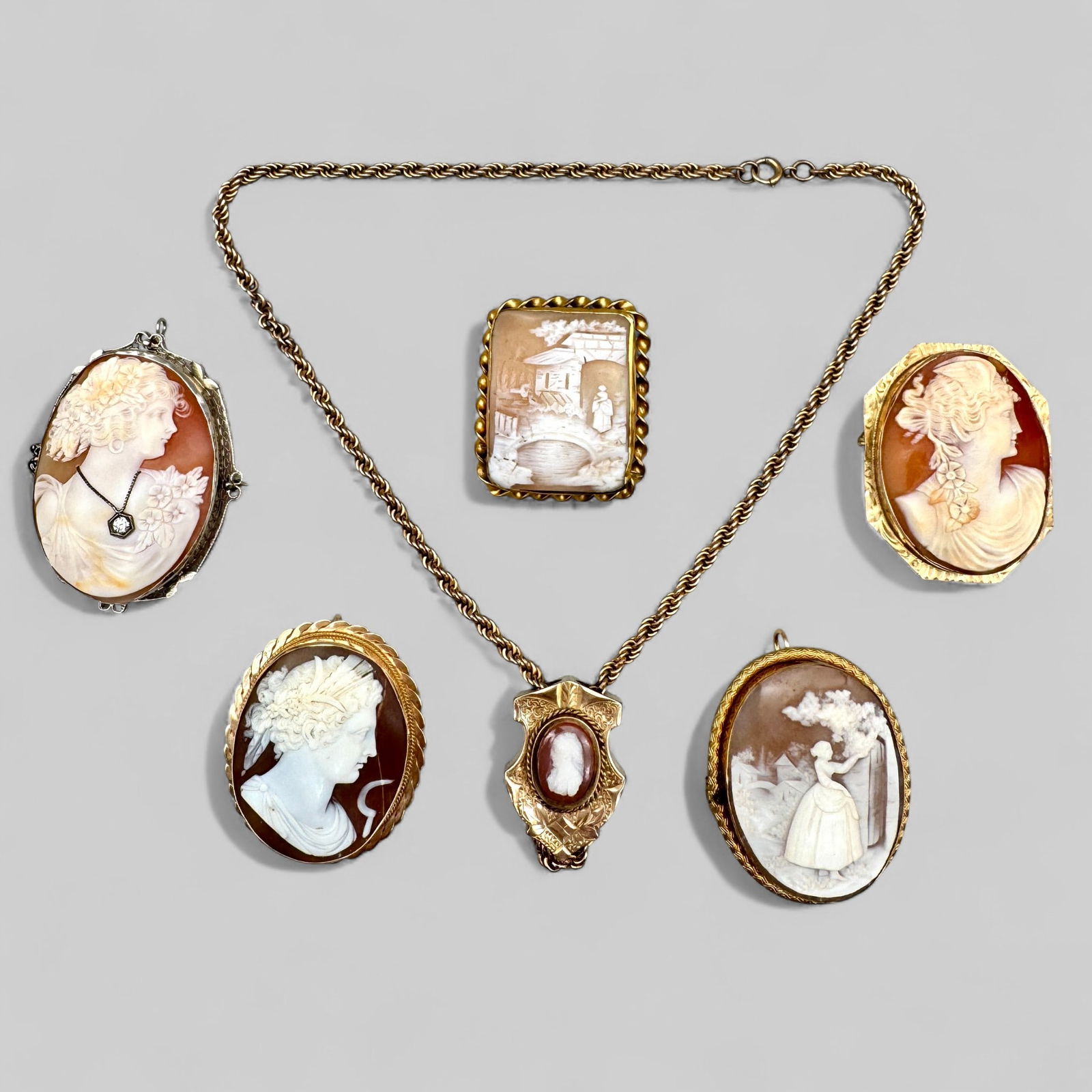 Collection of Cameos, Many 14k & 10k Bezels: 6 cameos, each with pin bezel, two of which are 10k, one testing for 14k, the other 3 gold filled.