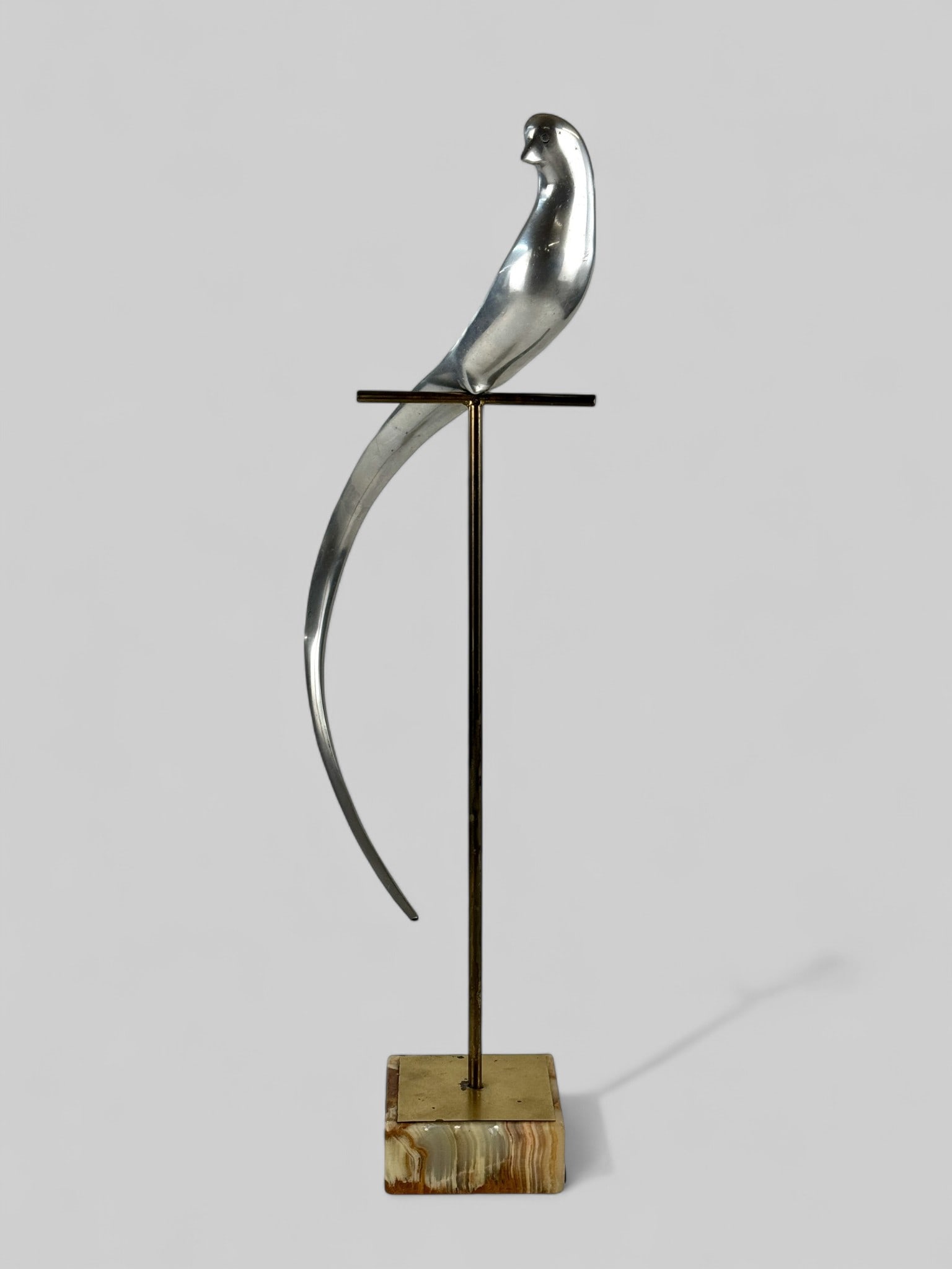 Bruce Cohen Modernist Bird Sculpture: Modernist steel bird sculpture, drilled with a hole in the base for sitting atop stand. Base of stand is marble with artist's plate affixed to side. Total height with stand: 29.5" ht.