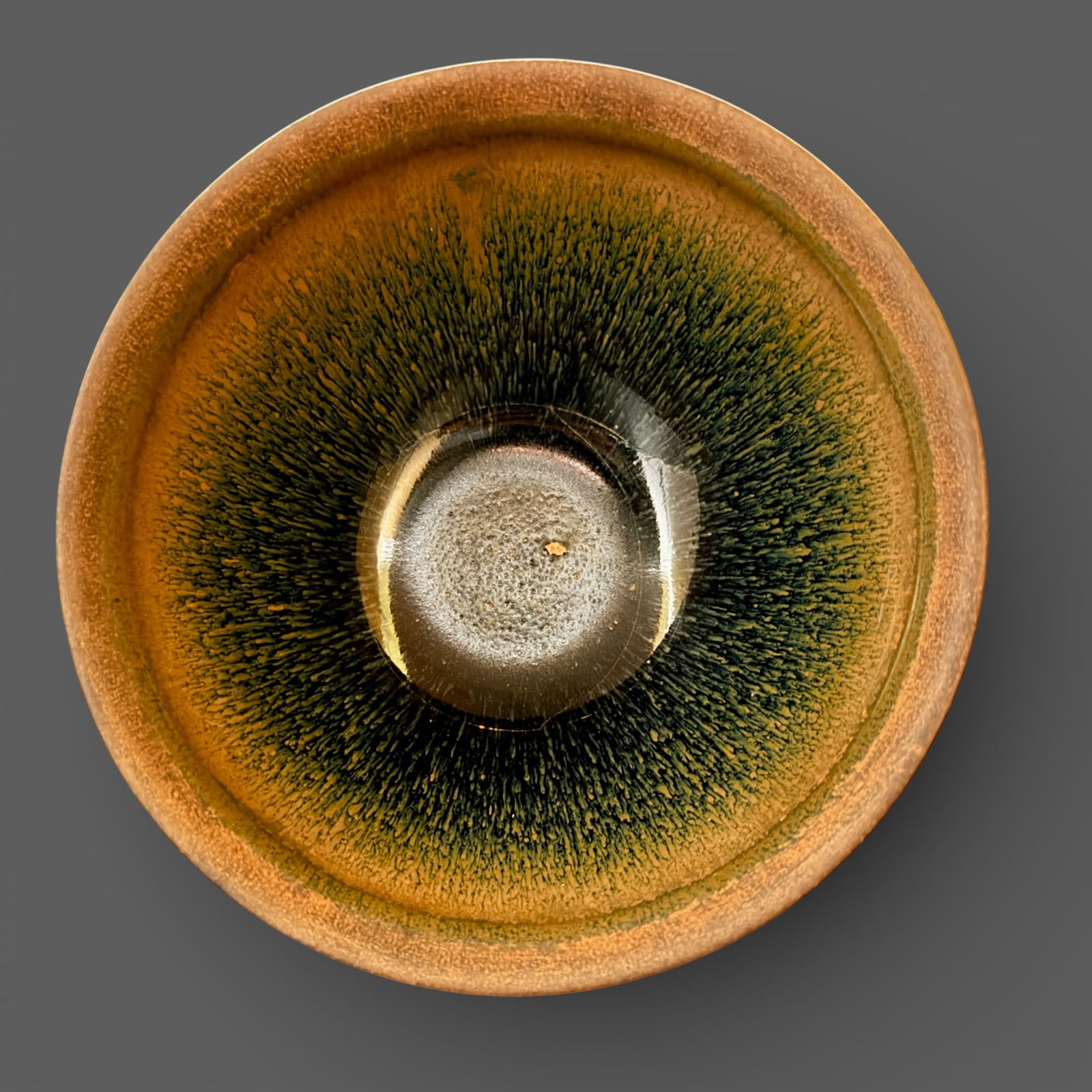 A Russet Streaked Jian "Hares Fur" Bowl: Southern Song dynasty. With russet streaks thoughout the interior and exterior of the bowl. Glaze is in fine shape and poos together nicely toward the foot. Diameter: 4 5/8" PROVENANCE