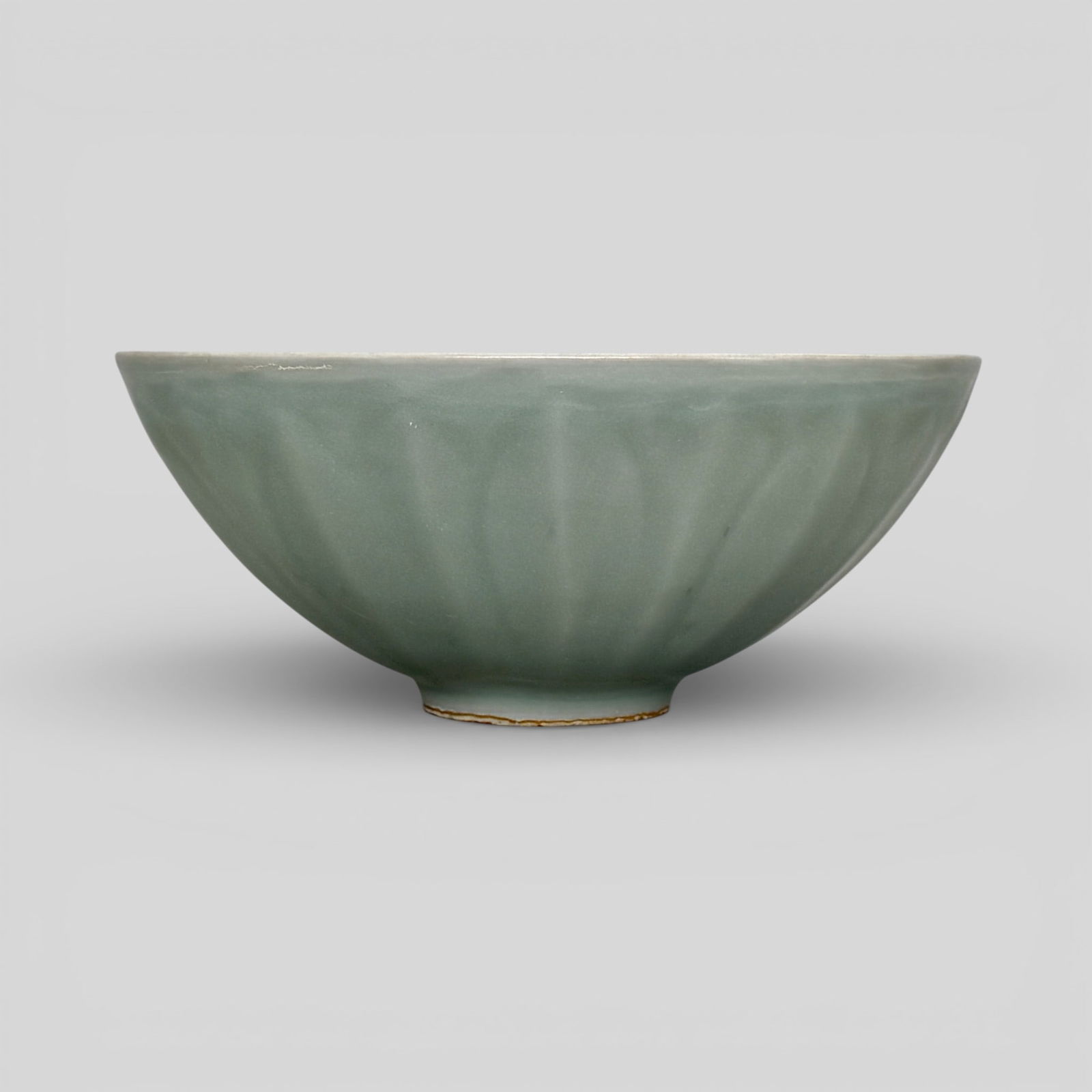 Longquan Celadon Lotus Bowl: Song/Yuan dynasty. Thinly potted. Exterior with carved lotus petals, foot unglazed, housed in box. Diameter: 6.5" PROVENANCE Private Collection, Columbus OHCollect