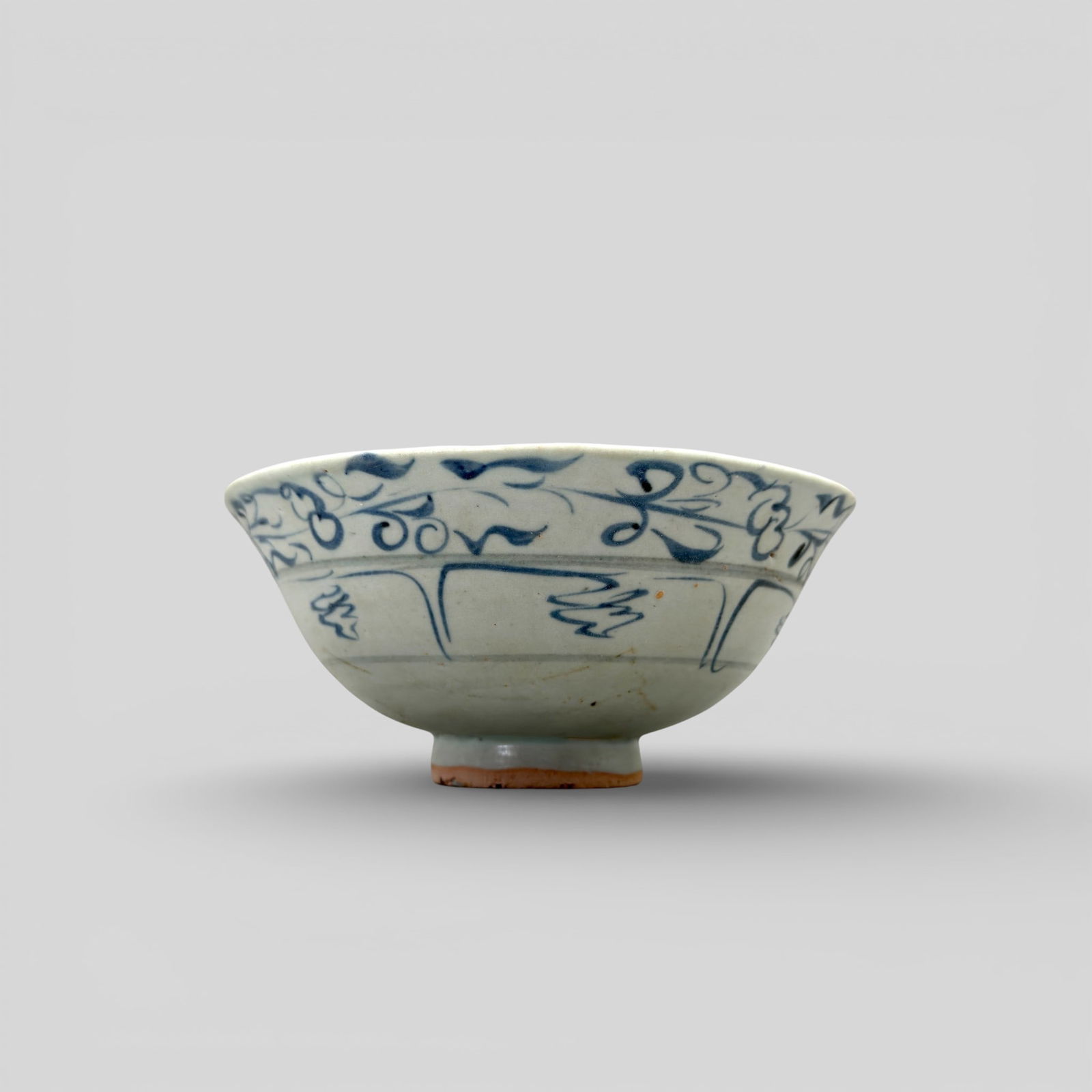 Porcelain Bowl with Underglaze Blue, Yuan: Decorated in grayish blue with a floral scroll and lotus panels on the outside, and a rim band of classic scroll on the inside. At bottom center is the flming pearl design. Diameter: 6.5" PRO