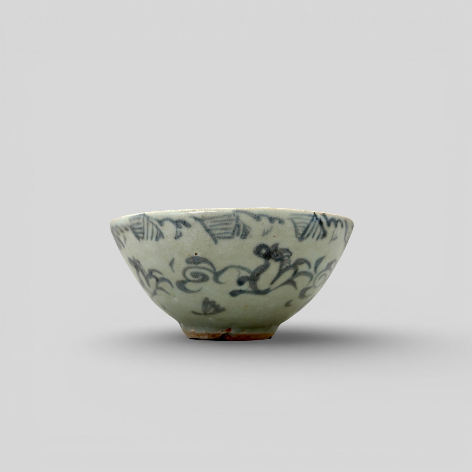 Porcelain Bowl with Underglaze Blue, Yuan: Decorated in an underglaze blue/gray. Excess clay to interior center and minor decoration. Exterior decorated with horselike figures, florals and scrolling pattern. Diameter: 5.5" PROVENANCE<