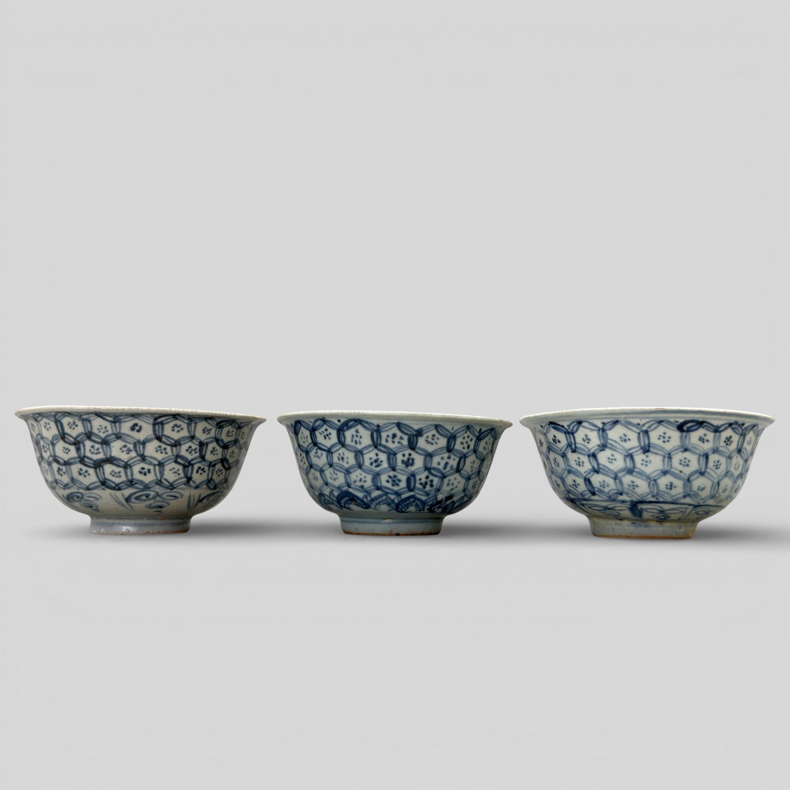 Ming Dynasty Blue and White Bowls: Three bowls, mid-Ming period. Each with diaper pattern to exterior, and each interior with beaded lace effect and floral sprays. All similarly sized, largest ht. 2.75", diameter 5.75". PROVEN