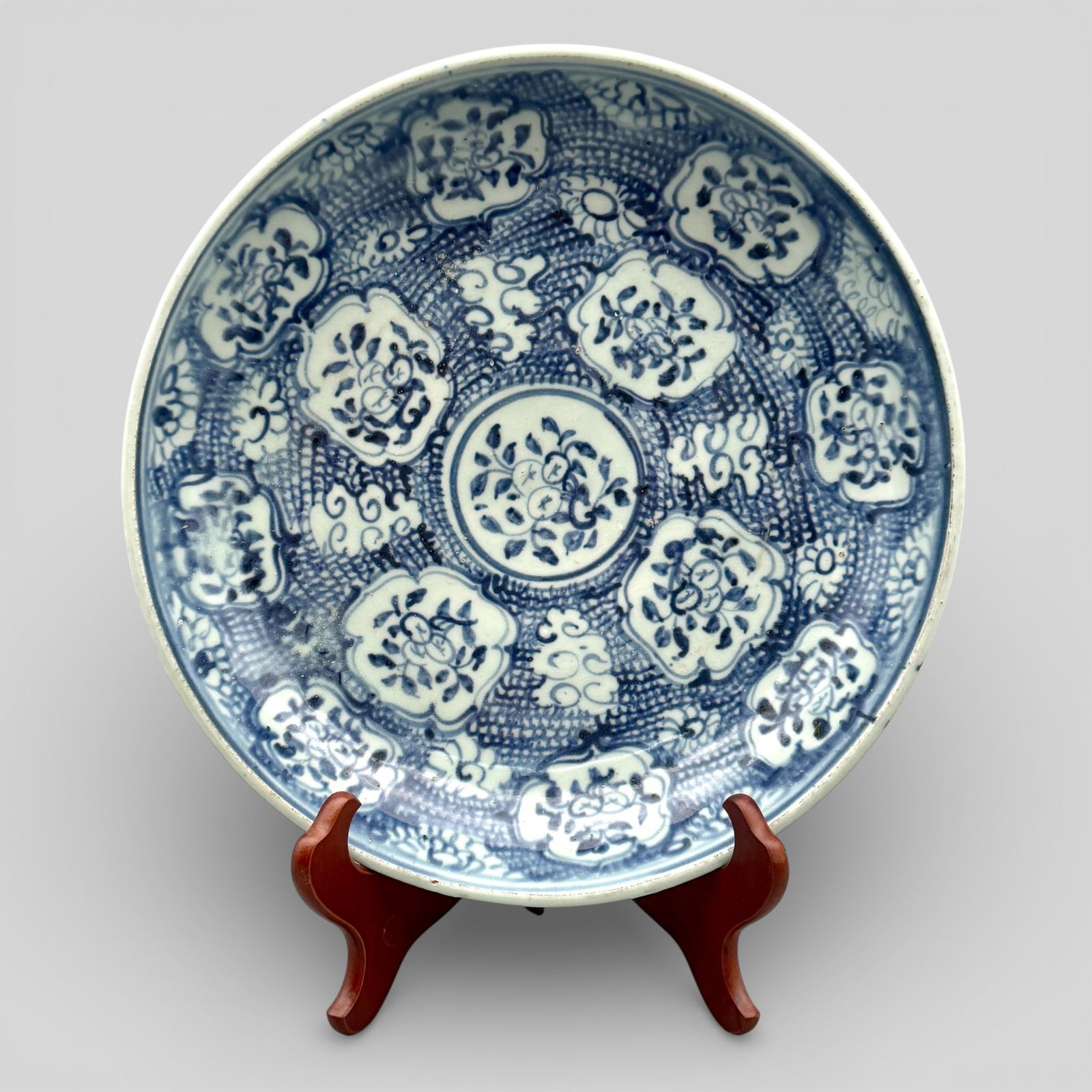 Large Ming Blue and White Charger: Interior decorated with fruiting flower. Four cloudlike designs and 12 medallions encircle the interior decoration. Florals to exterior. Diameter: 12.75" PROVENANCE Priv