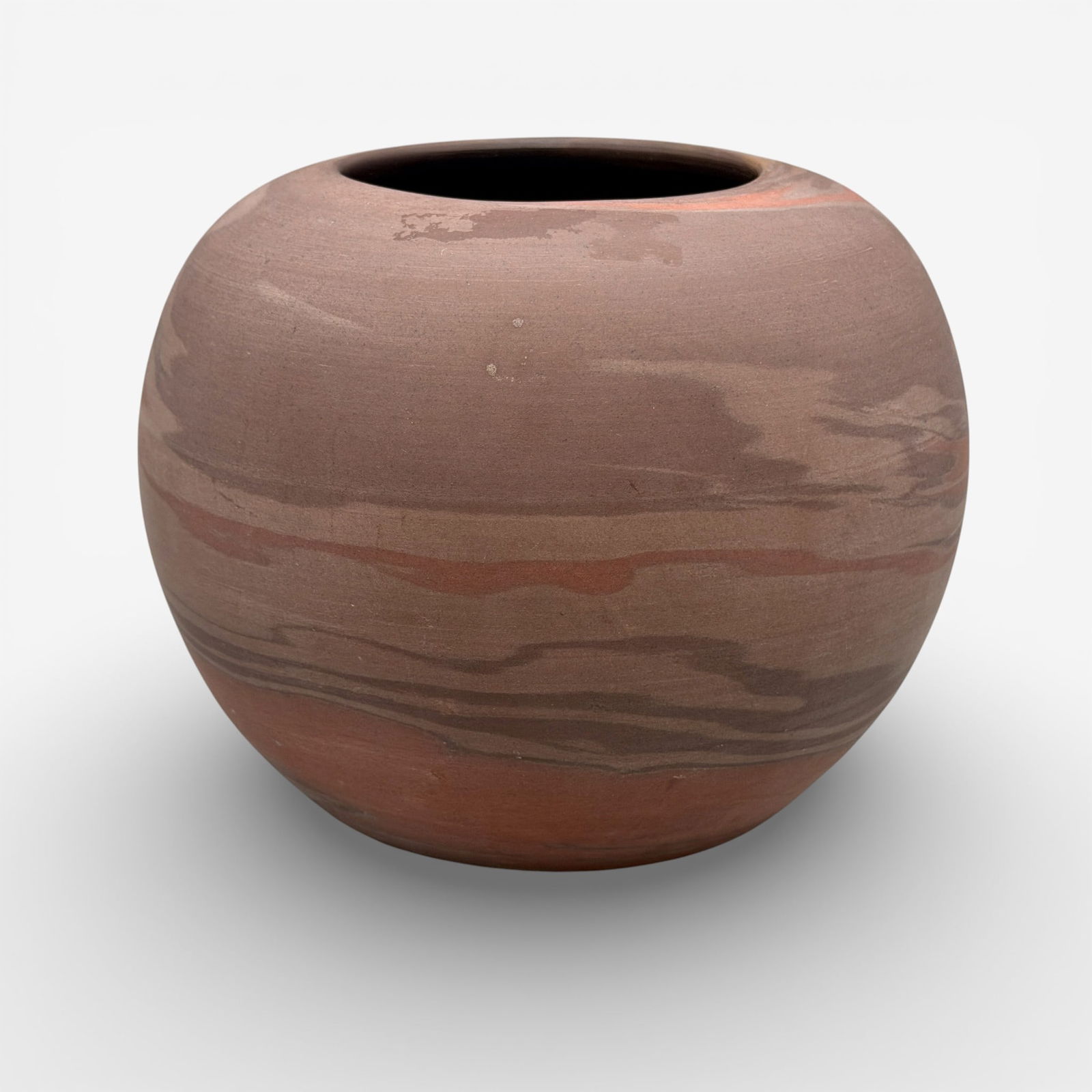 Niloak vase with deep, rich earth colors: Niloak vase with rich, deep shades of red and brown. Impressed logo.