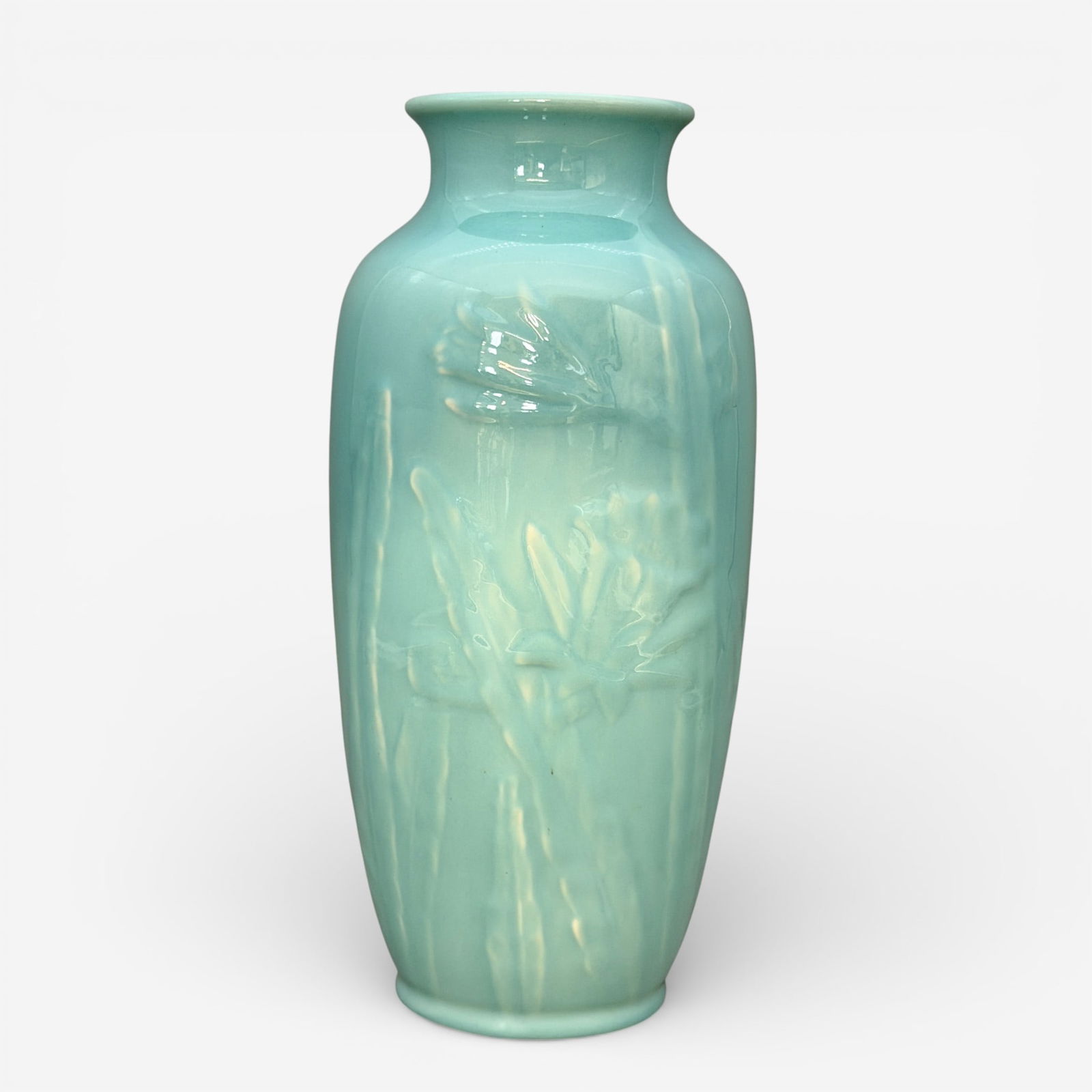 Rookwood production vase, jonquils, 1946: Rookwood production vase with embossed jonquils, a Shirayamadani design done in glossy blue glaze in 1946. Impressed Rookwood logo, XLVI, shape number 6870. Height 11 5/8 inches.