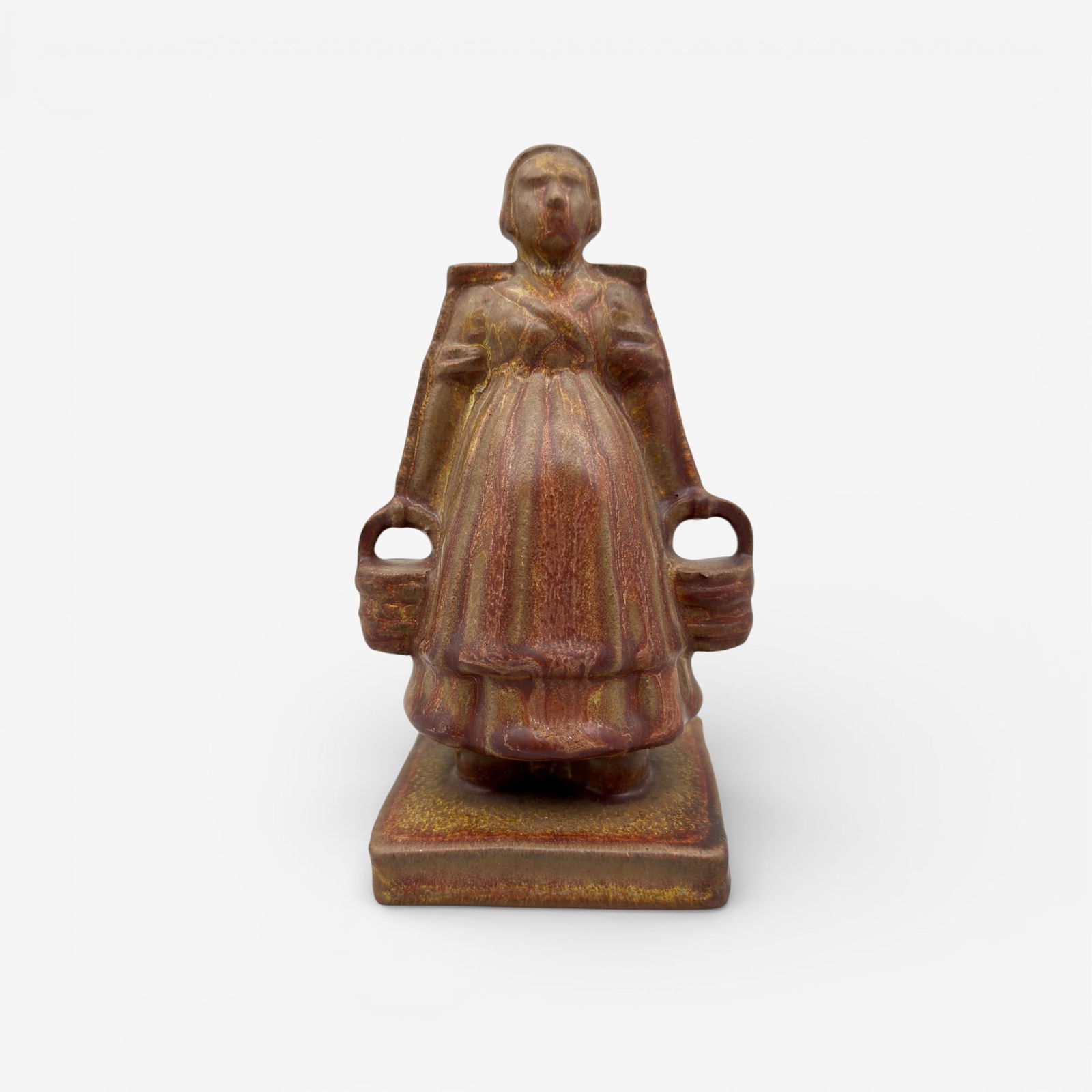 Rare Dutch Girl paperweight, Rookwood, 1911: Rare Dutch Girl carrying two pails, a Rookwood paperweight in Ombroso glaze, designed by Albert Pons and produced in 1911. Impressed Rookwood logo, XI, shape number 1854.