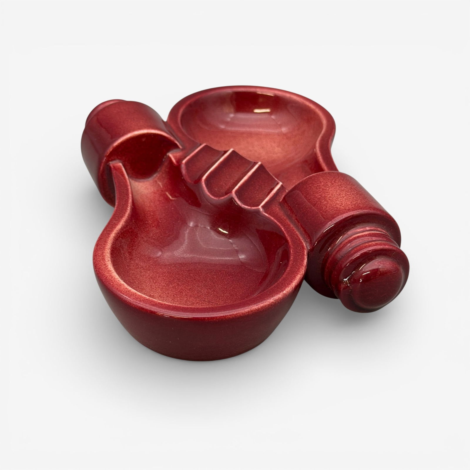 Roowood General Electric lightbulb tray, 1949: Rookwood tray in maroon high glaze, the form of two lightbulbs side by side, an advertising piece made for General Electric in 1949. Raised GE, logo, impressed Rookwood logo and XLIX. Height 1 5/8 inc