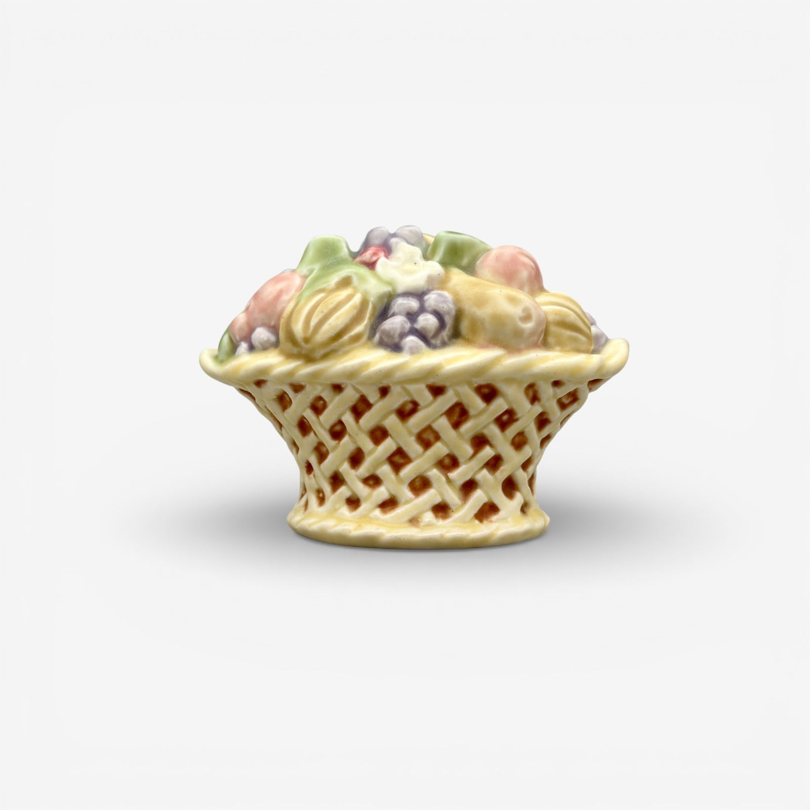 Rookwood Flower Basket paperweight, polychromed, 1928: Polychromed Rookwood "Flower Basket" paperweight, a Sallie Toohey design done in 1928. Impressed Rookwood logo, XXVIII, ST and shape number 6020. Height 3 1/8 inches.