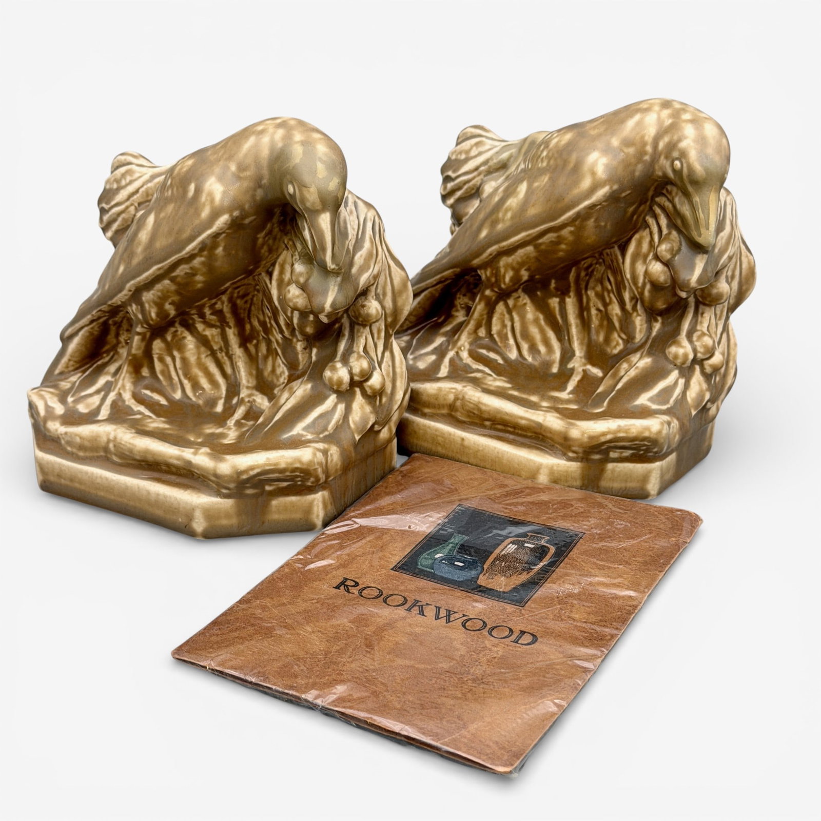 Pair of Rookwood "Rook" bookends, 1926: Pair of Rookwood "Rook" bookends in tan mat glaze from 1926. Impressed Rookwood logo, XXVI, shape number 2275. Height 5 1/2 inches.