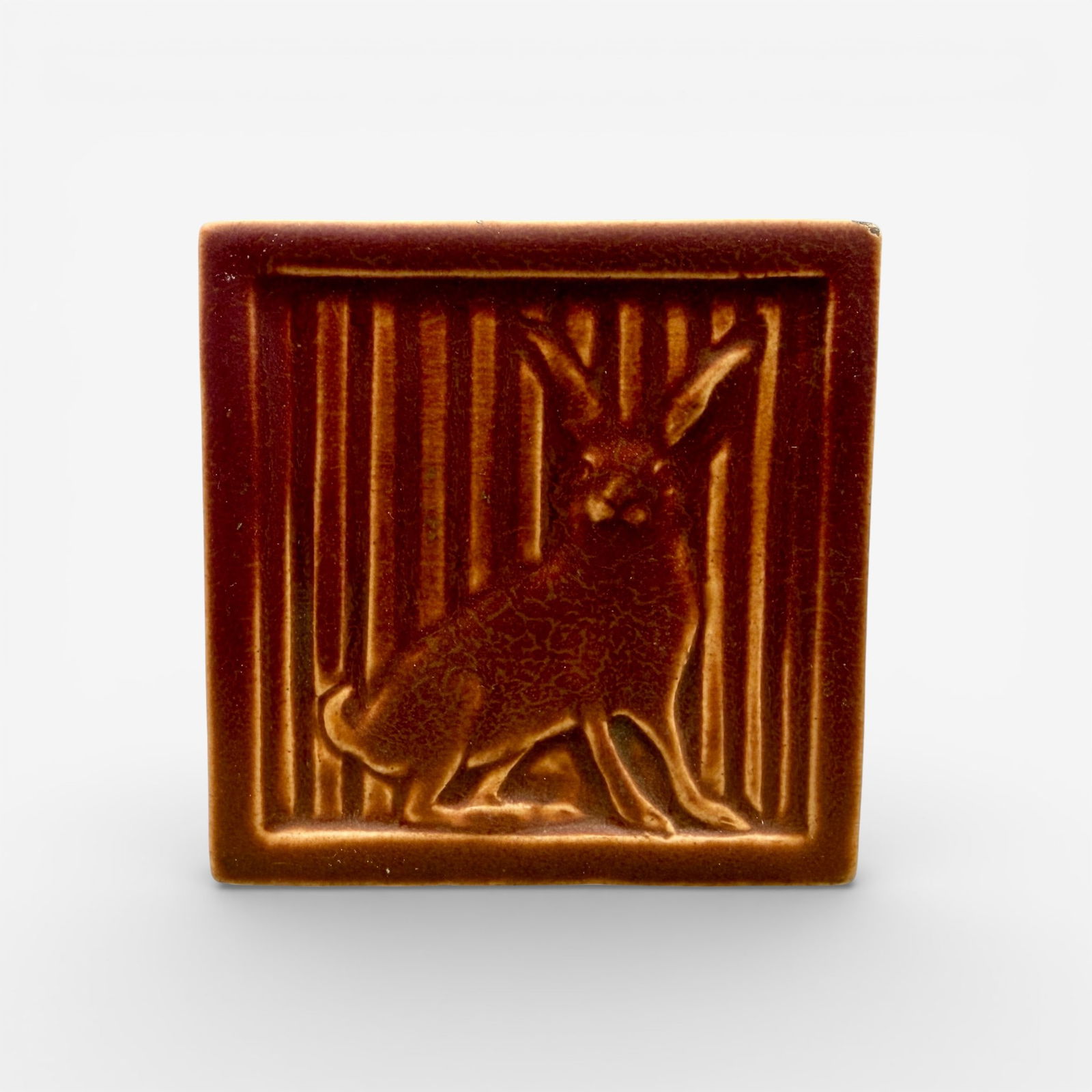 Uncommon Rookwood Rabbit tile, 1913: Rookwood "Rabbit" tile in rose mat glaze, dated 1913. Impressed Rookwood logo XIII, Shape number 2052, Wheel ground X. Size 3 5/8 by 3 5/8 inches.